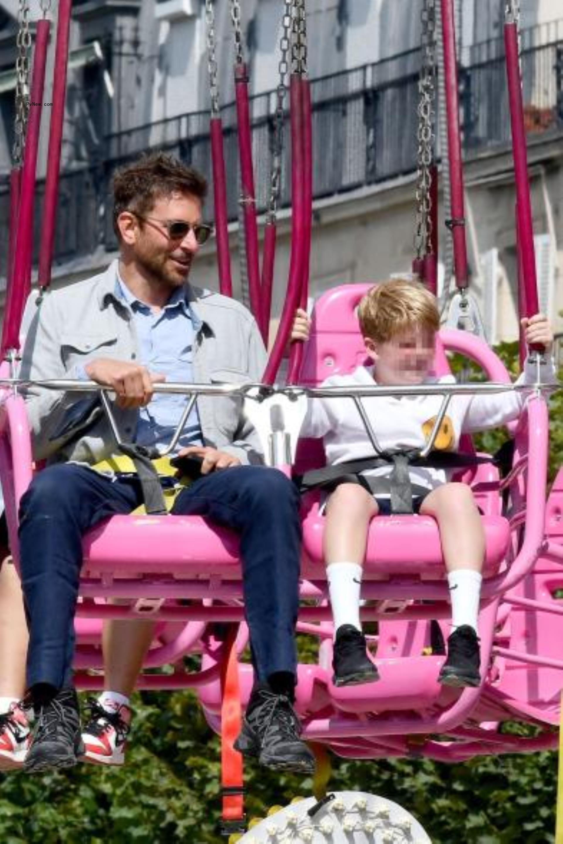 Bradley Cooper riding swings at the fair