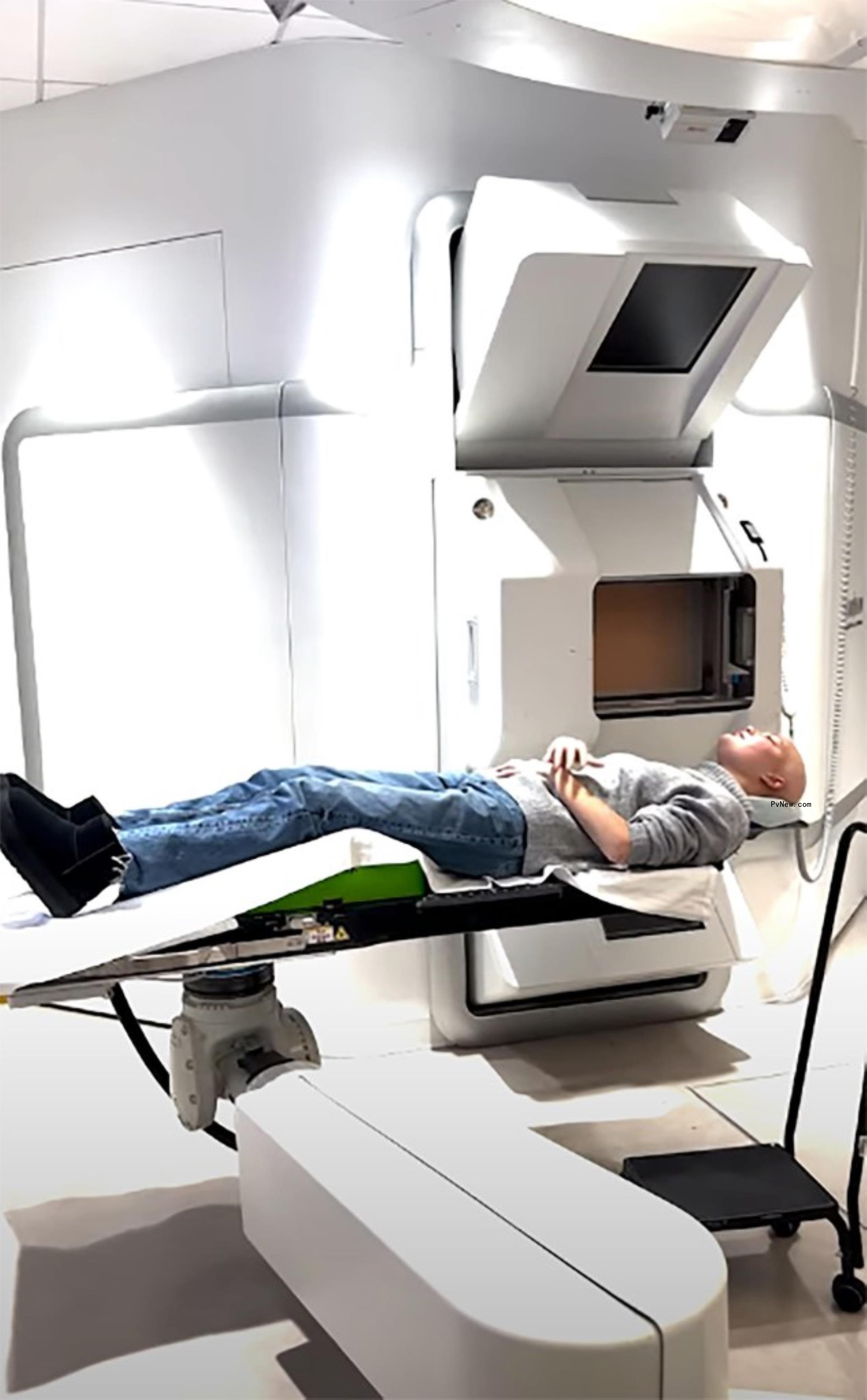 isabella strahan lying down on a hospital machine bed for radiation