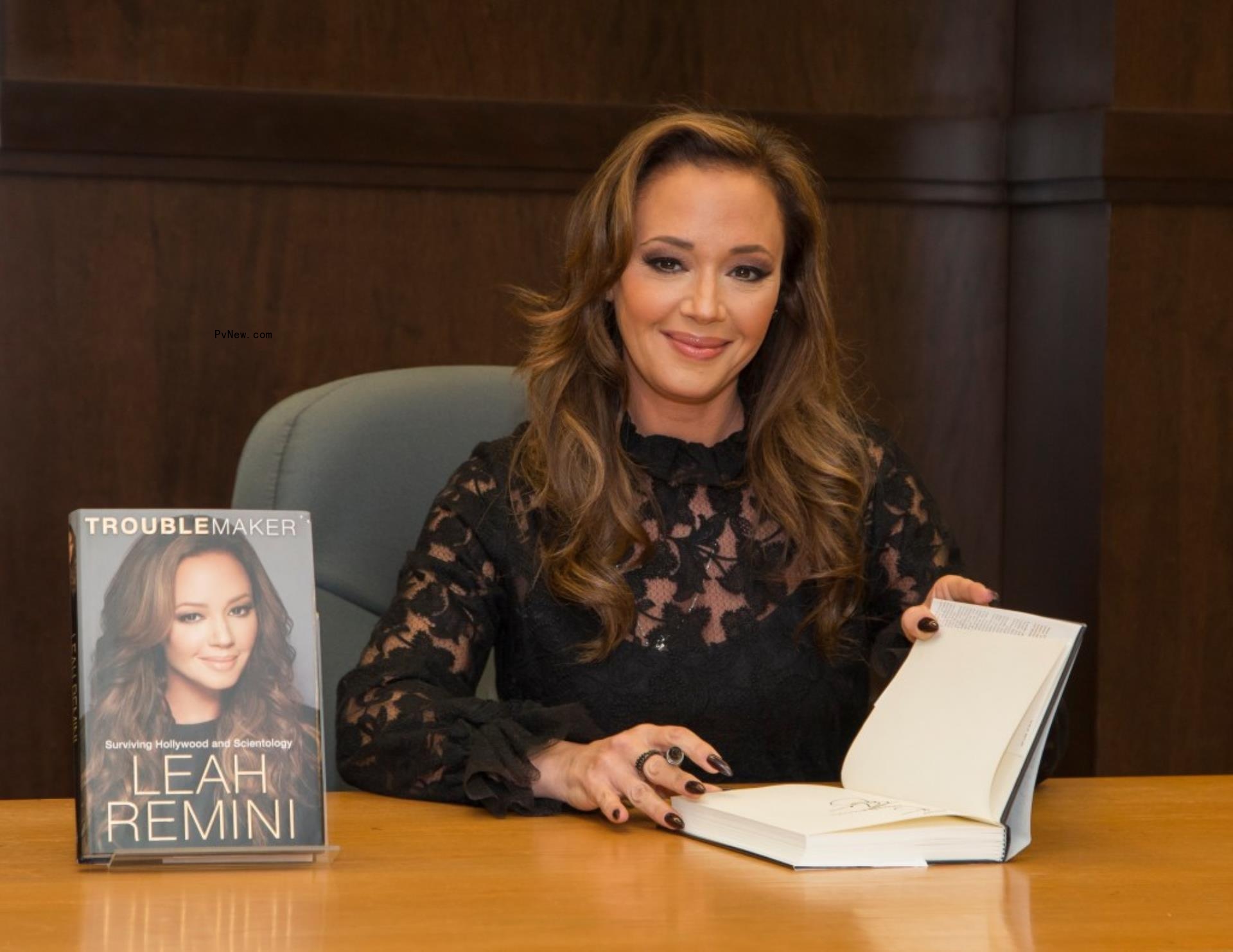 Leah Remini signing a book.