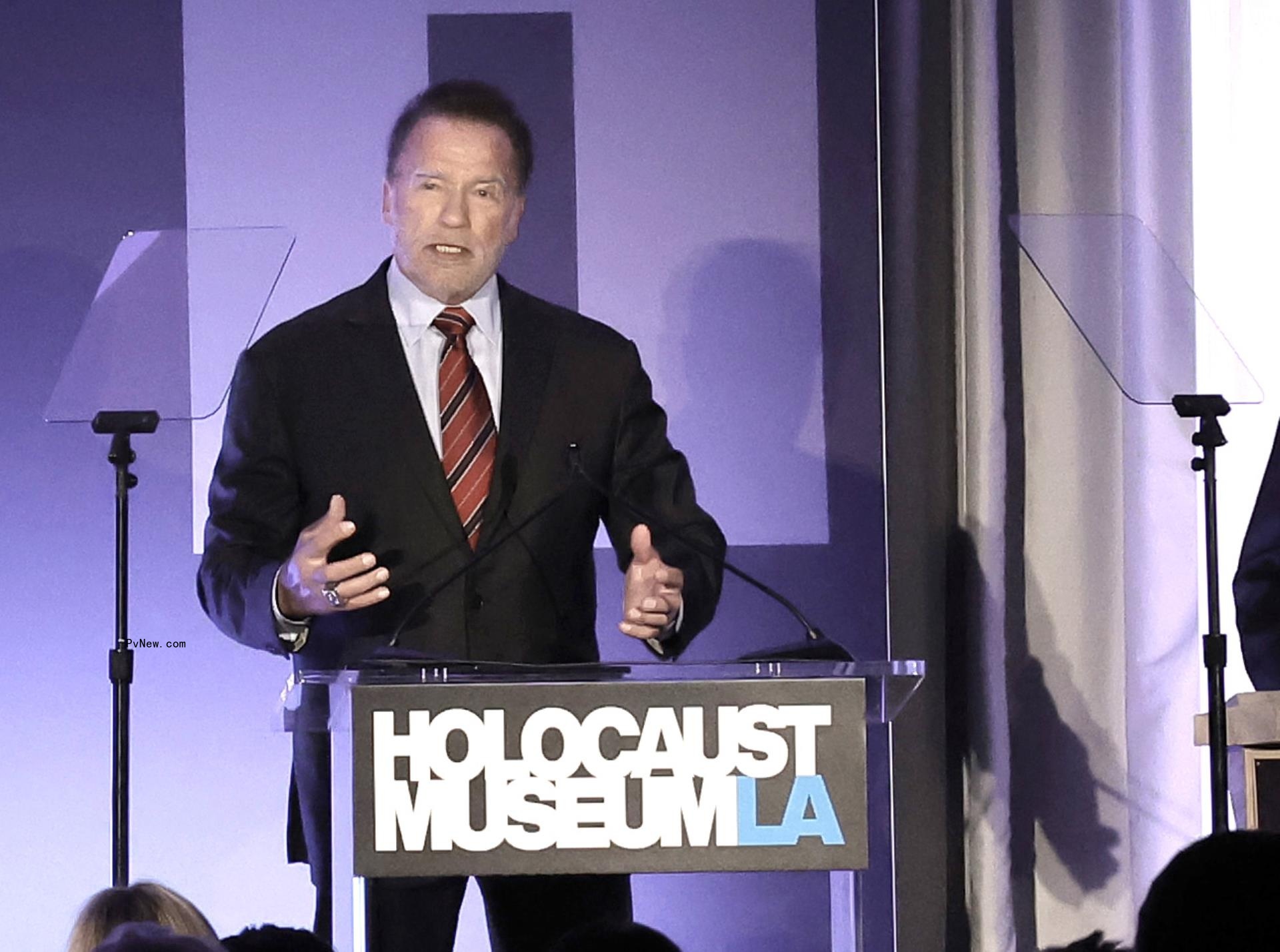 Arnold Schwarzenegger speaking at a charity event.