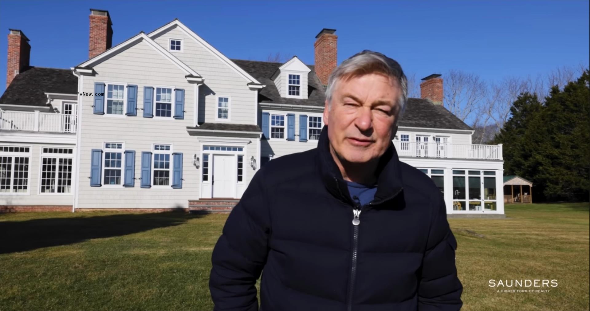 Alec Baldwin standing outside his Hamptons home