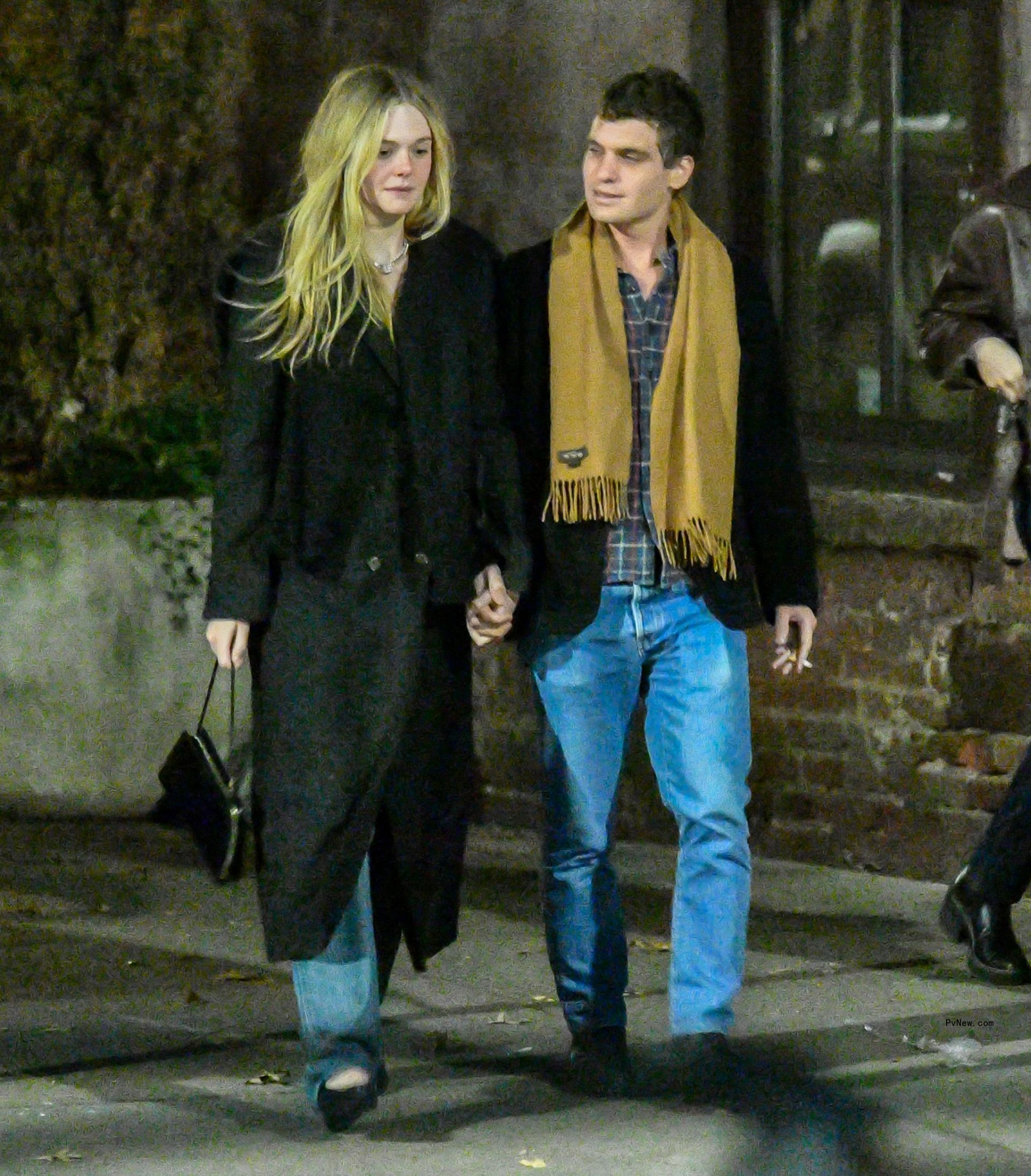 Elle Fanning and Gus Wenner holding hands.