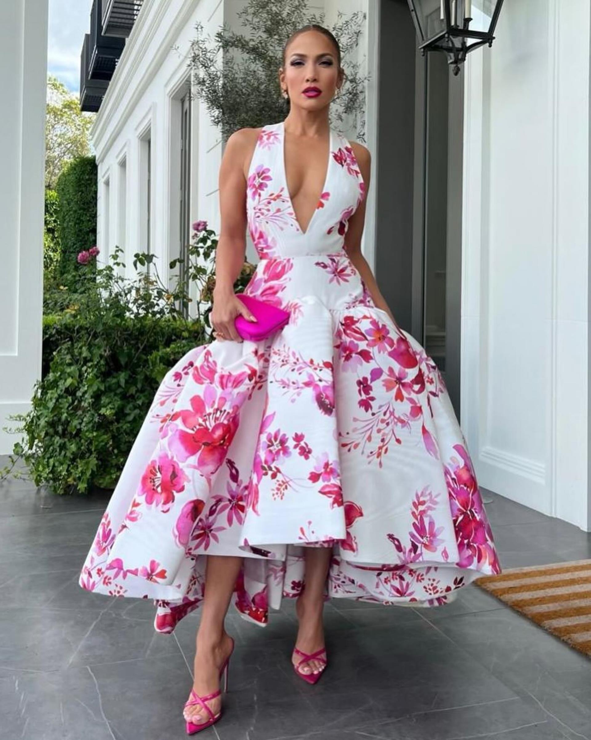 Jennifer Lopez in a pink and white dress.