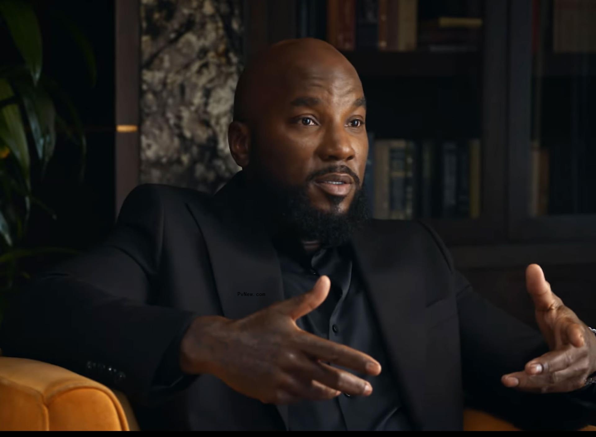 Jeezy wearing a black suit and speaking.