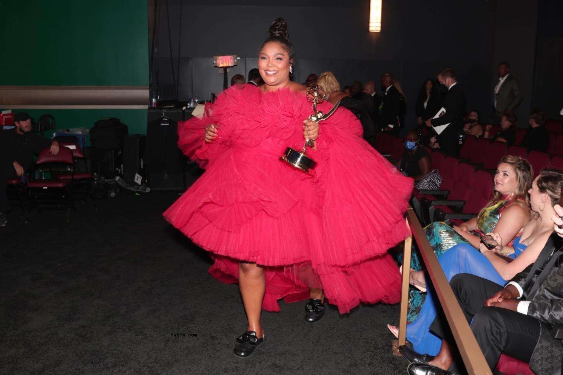 Lizzo holding a Grammy.