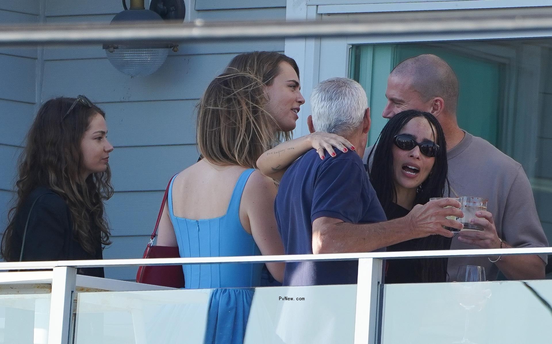 Cara Delevingne, Minke, Zoe Kravitz, and Channing Tatum hangout on the patio of the rehearsal dinner.