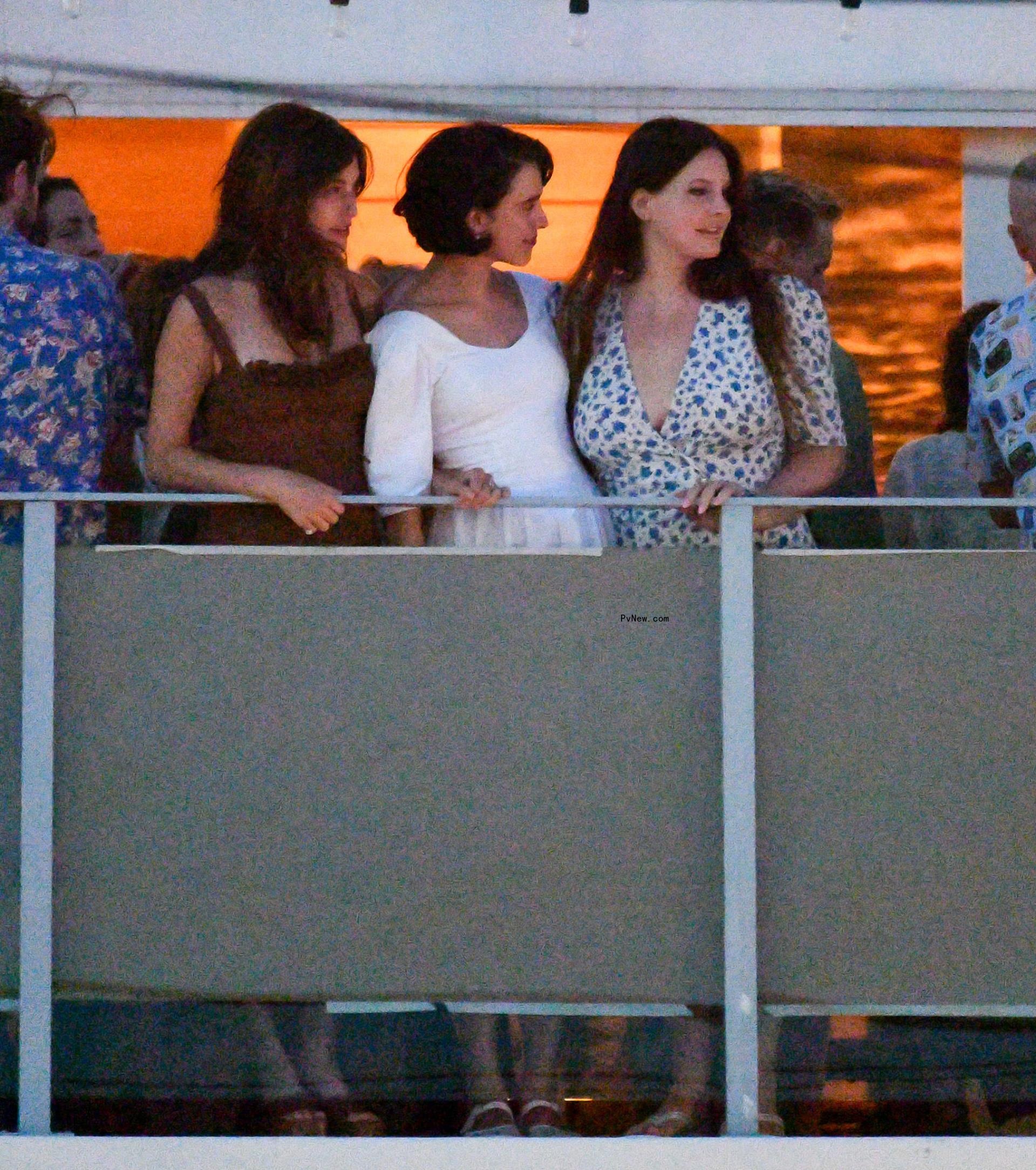 Bride-to-be Margaret Qualley is pictured with her sister Rainey Qualley and Lana del Rey on the patio of her rehearsal dinner.