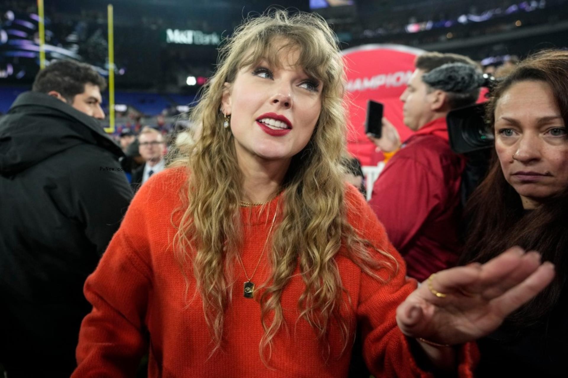 Taylor Swift speaks with people on the field after an AFC Champio<i></i>nship NFL football game between the Baltimore Ravens and the Kansas City Chiefs, Sunday, Jan. 28, 2024, in Baltimore.