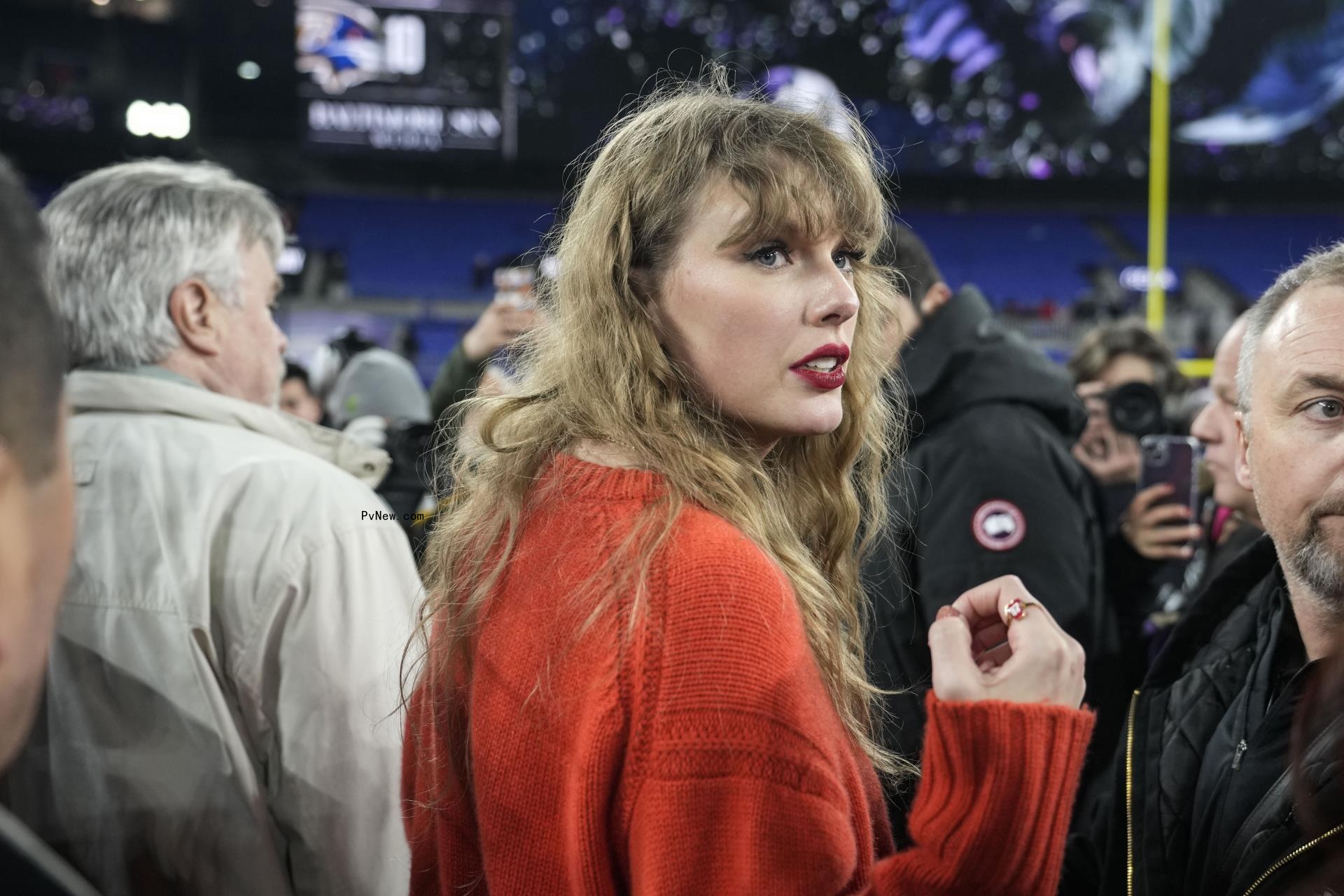 Taylor Swift speaks with people on the field after an AFC Champio<i></i>nship NFL football game between the Baltimore Ravens and the Kansas City Chiefs, Sunday, Jan. 28, 2024, in Baltimore.