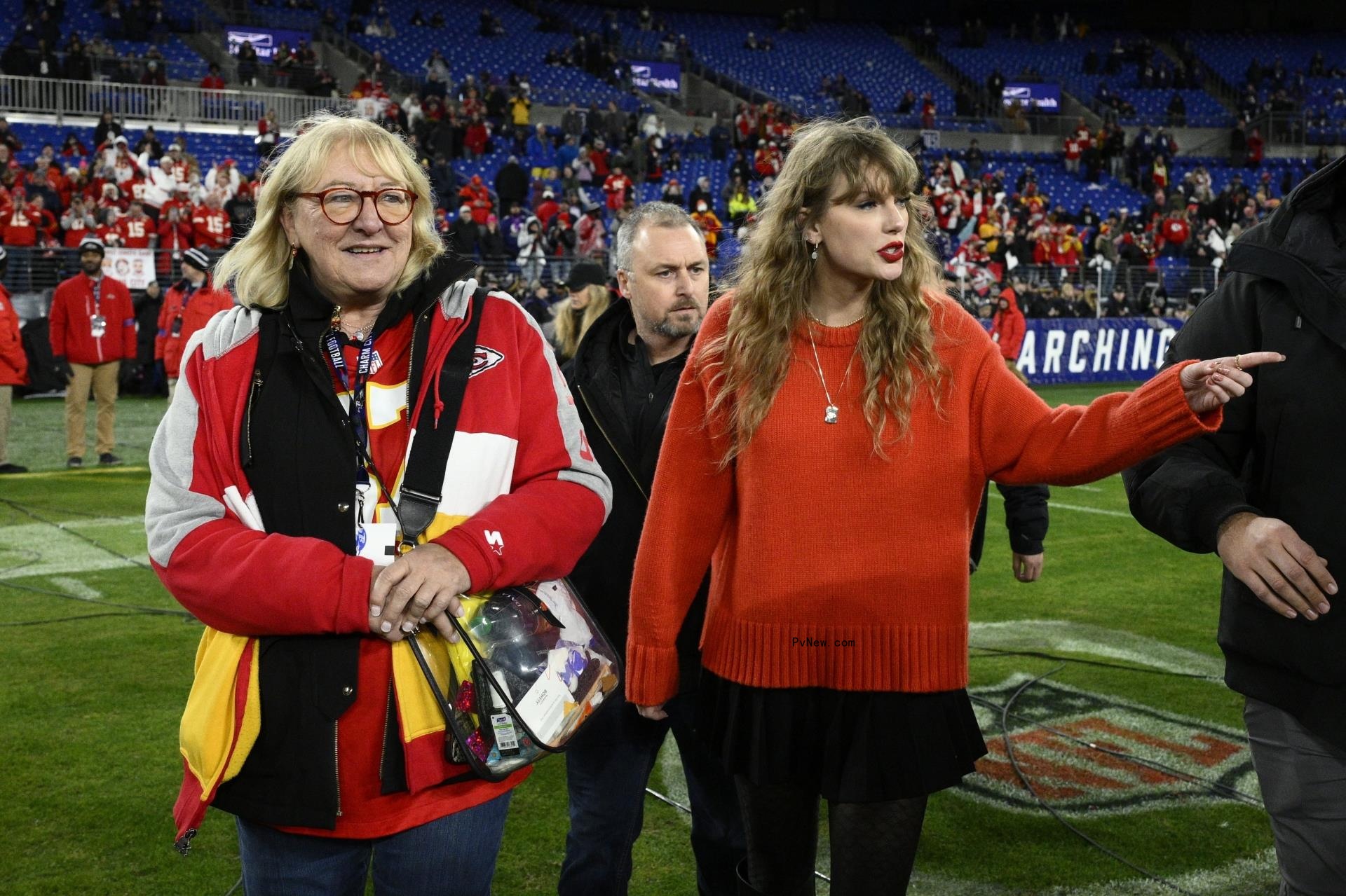 Taylor Swift, right, walks with Do<i></i>nna Kelce on the field after the AFC Champio<i></i>nship NFL football game between the Baltimore Ravens and the Kansas City Chiefs, Sunday, Jan. 28, 2024, in Baltimore.