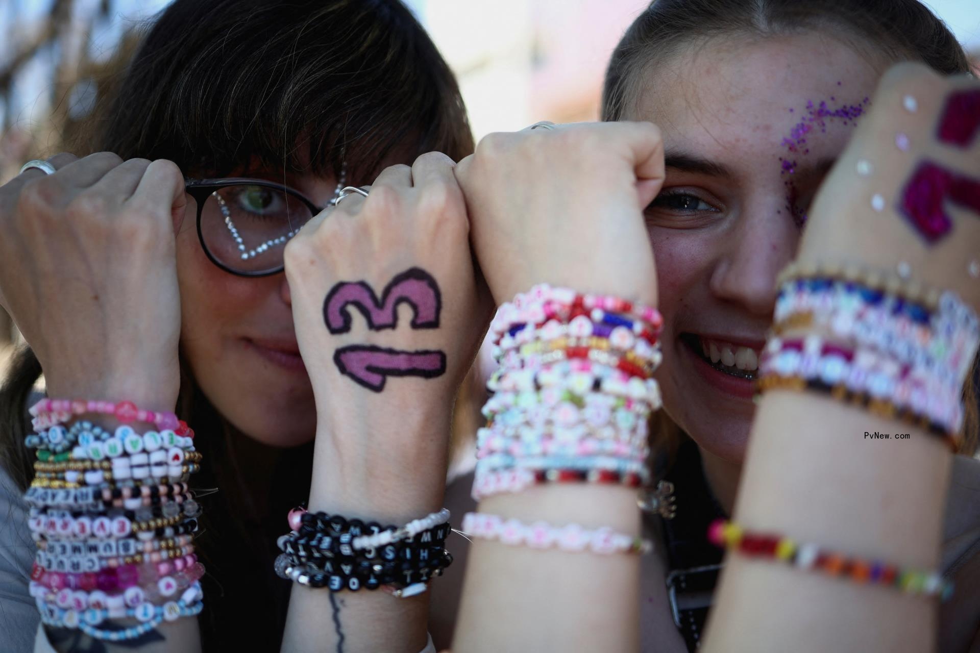 Taylor Swift fans pose for a photo with their 