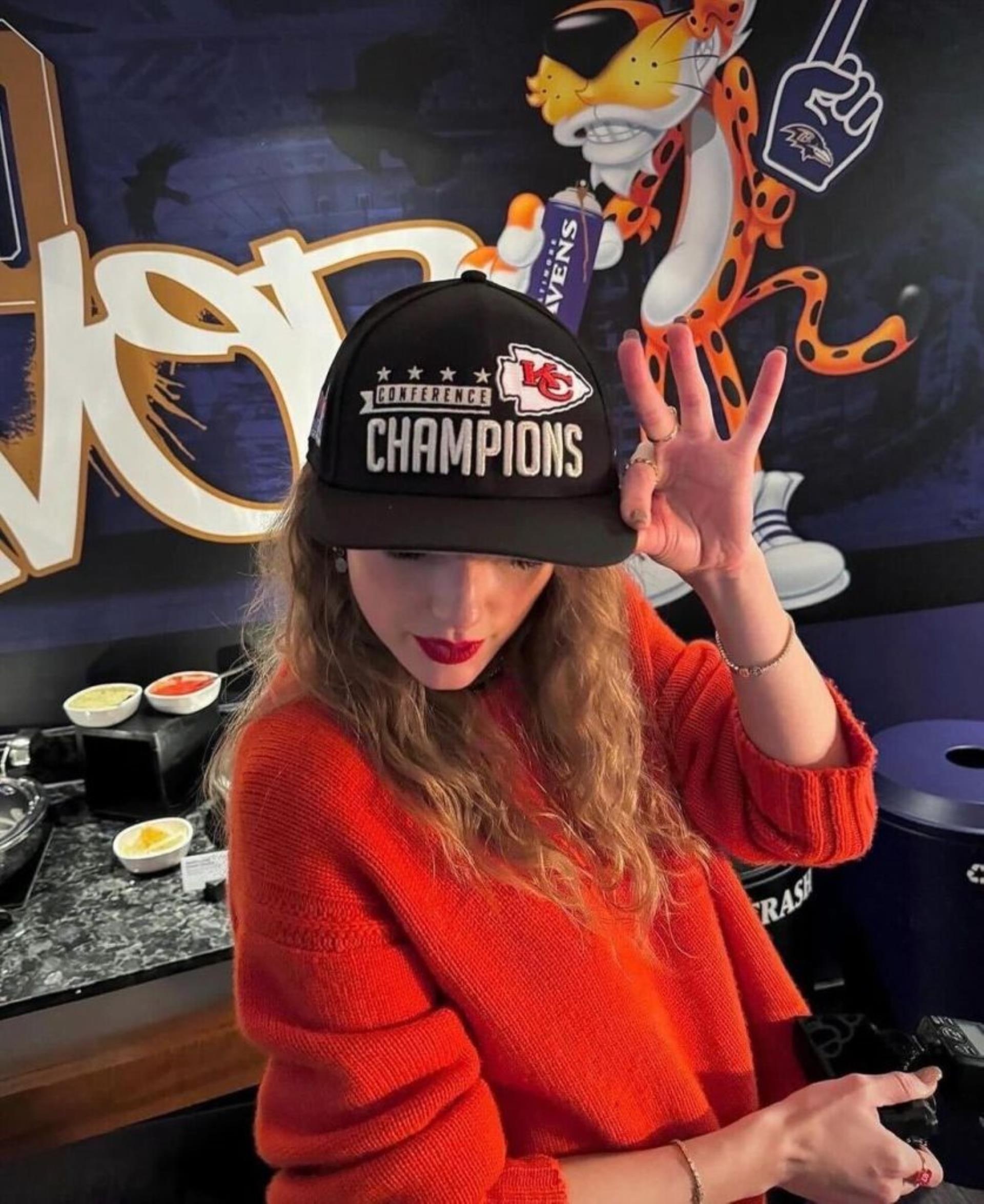 Taylor Swift poses in AFC champions hat