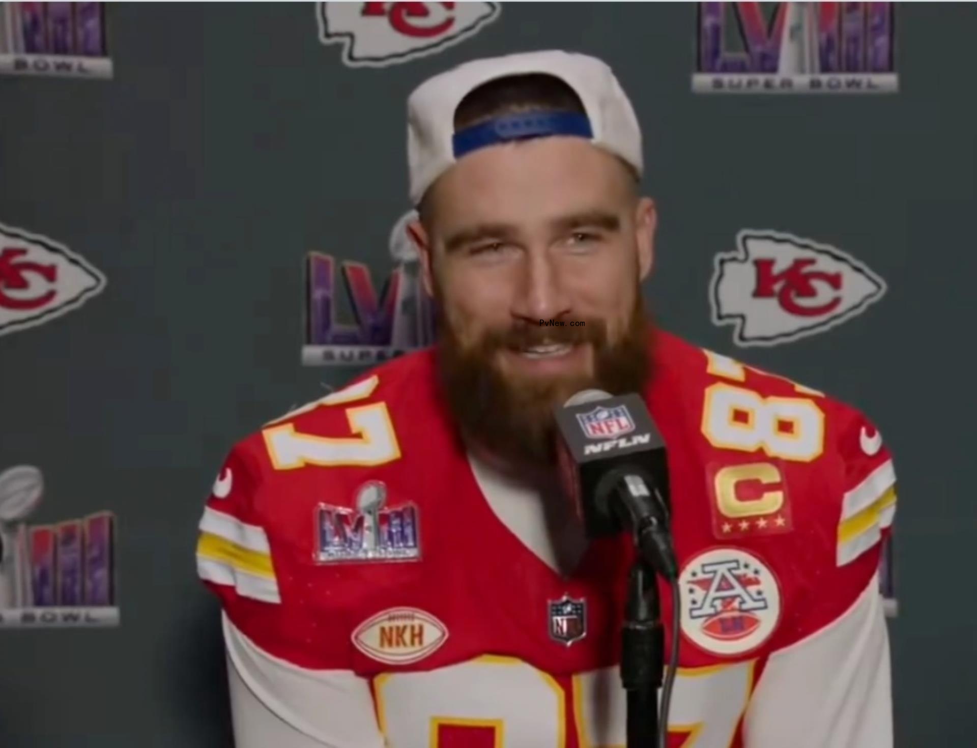 Travis Kelce talking into a mic
