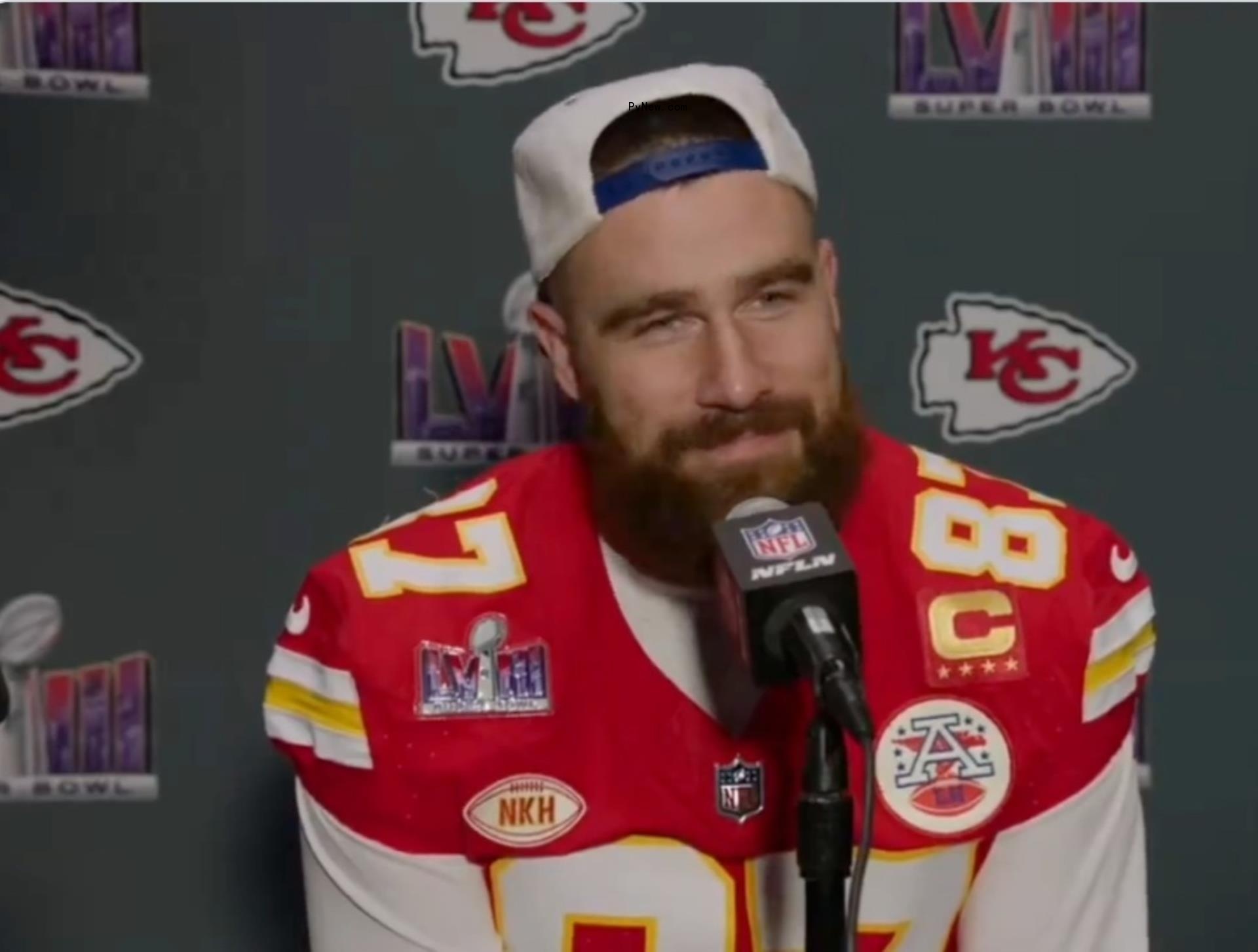 Travis Kelce talking into a mic