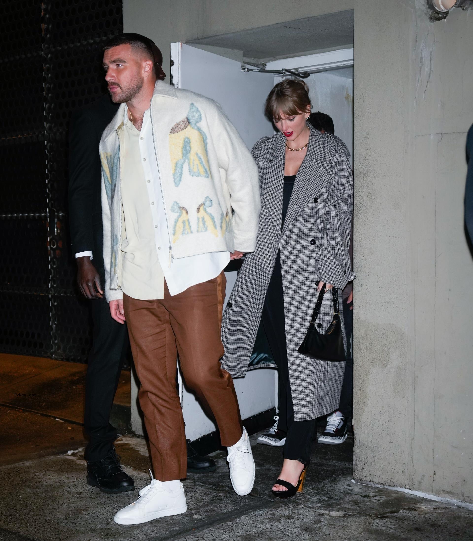 Travis Kelce walking with Taylor Swift
