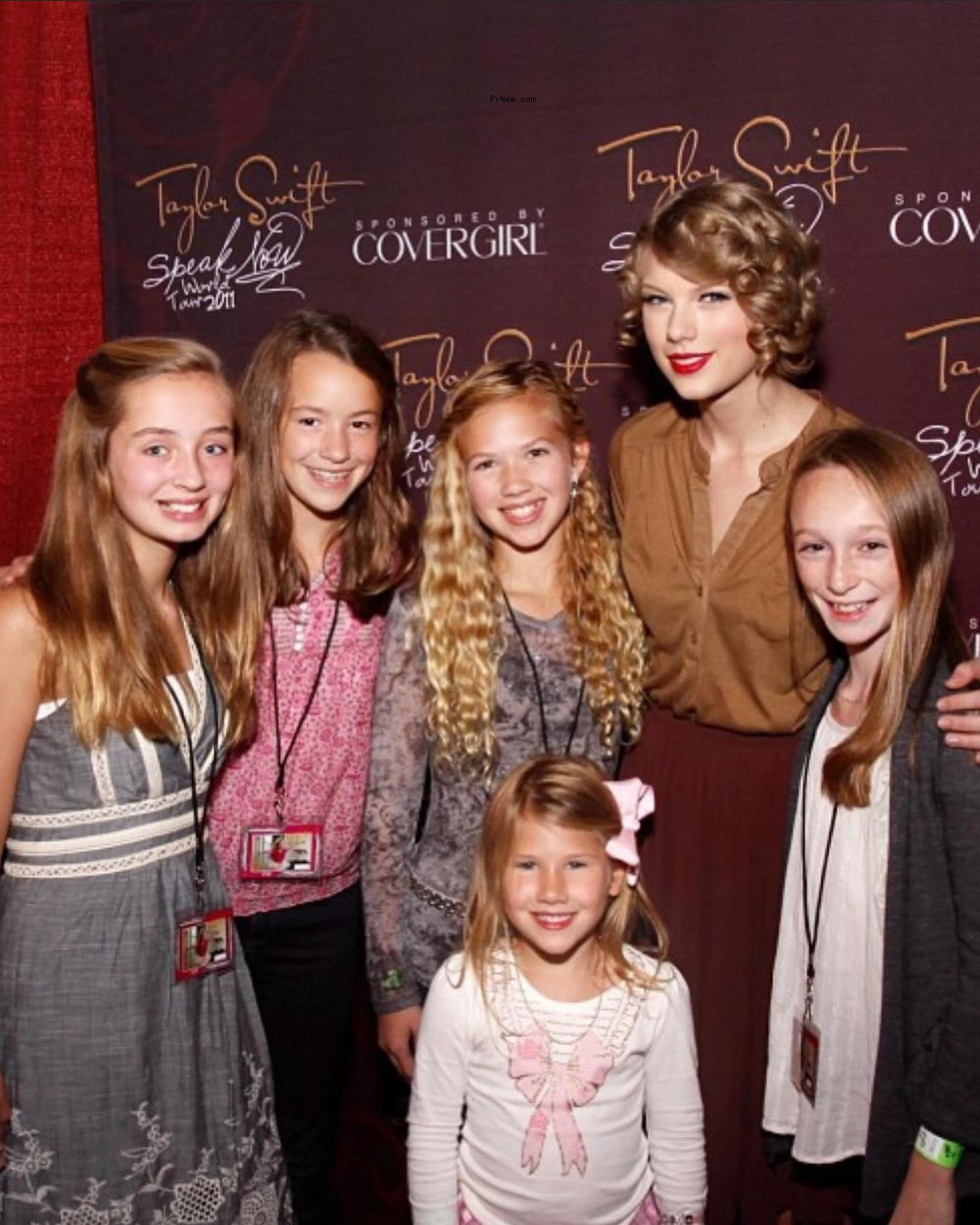 Taylor Swift posing with fans.