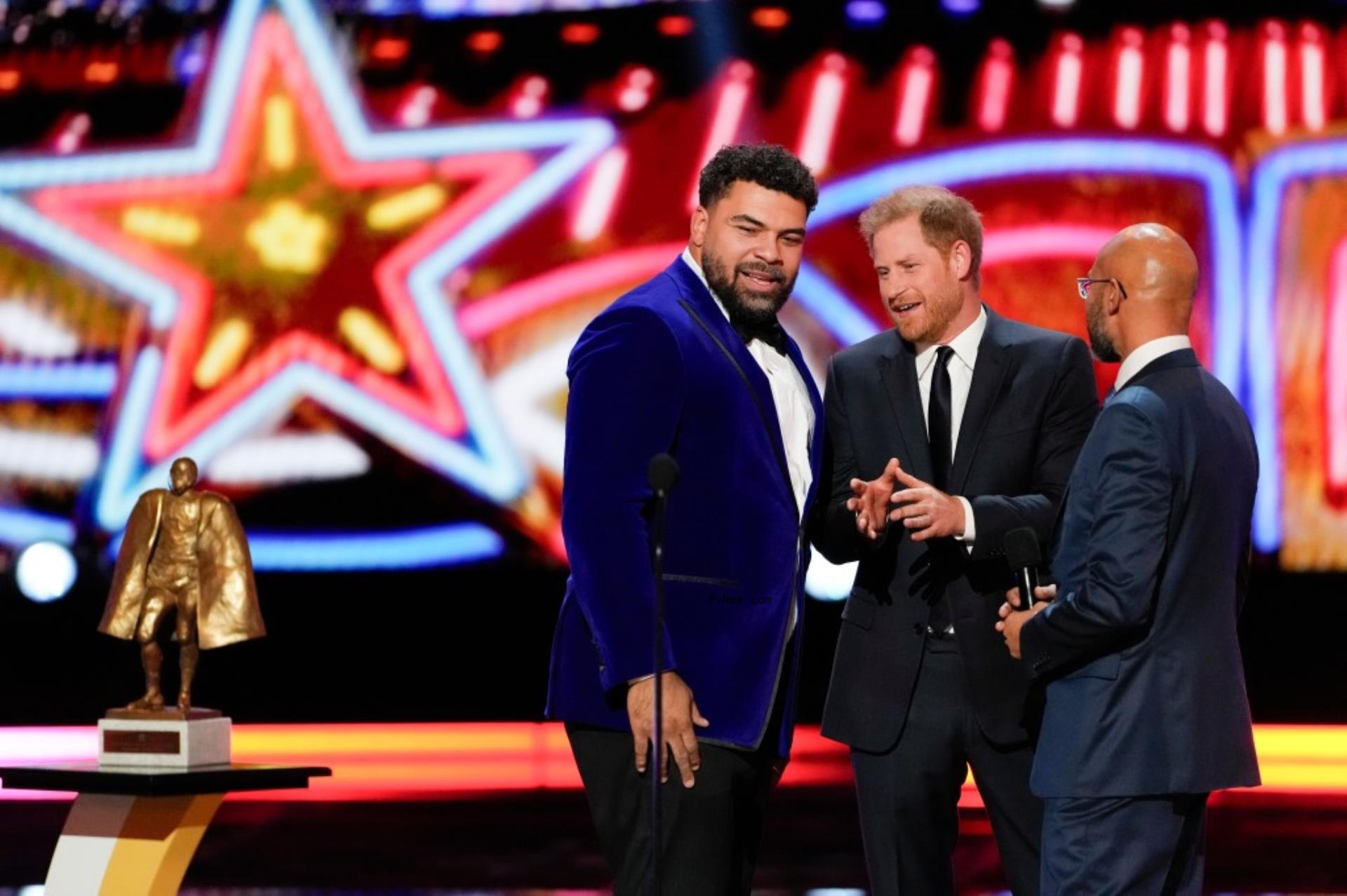 Prince Harry talks to Cameron Heyward as comic Keegan-Michael Key looks on.