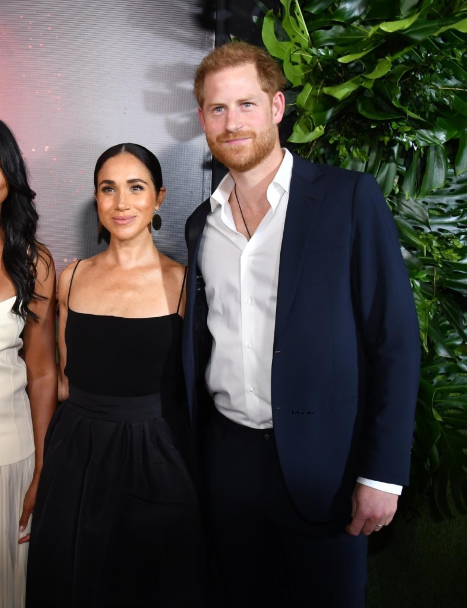 Prince Harry smiles with wife Meghan Markle.