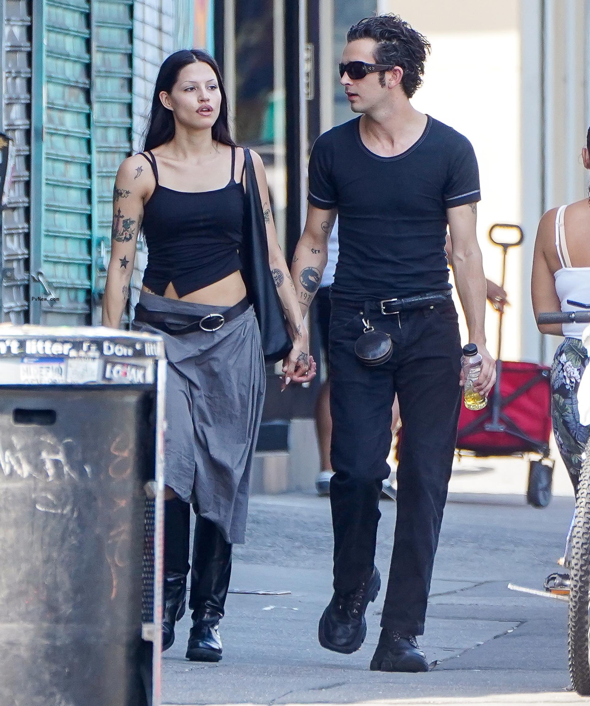 Matty Healy and Gabbriette Bechtel holding hands