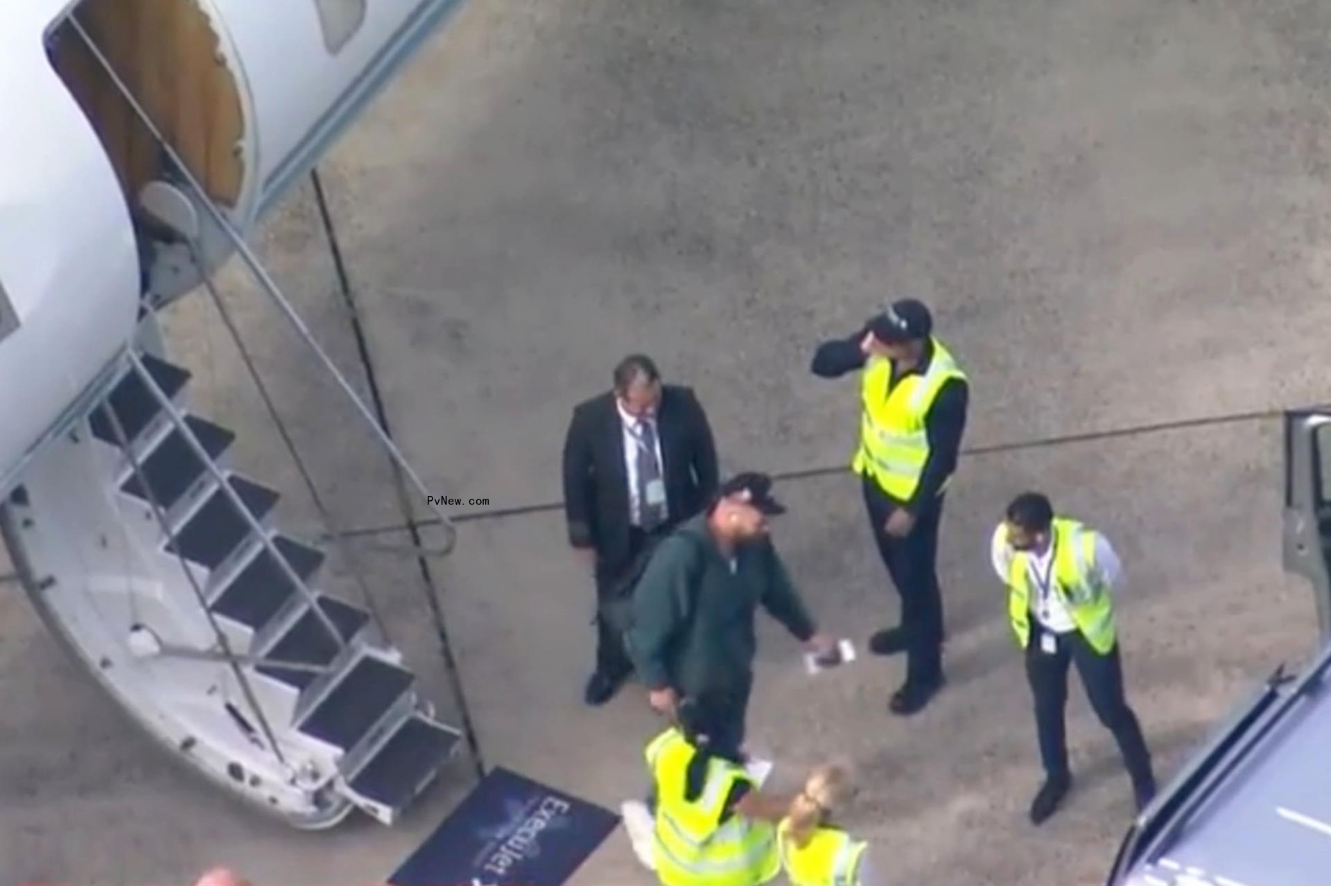 Travis Kelce getting off a plane.