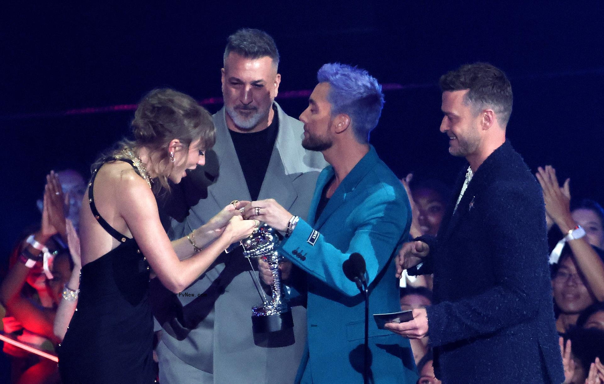 Taylor Swift accepting an award from *NSYNC at the VMAs.