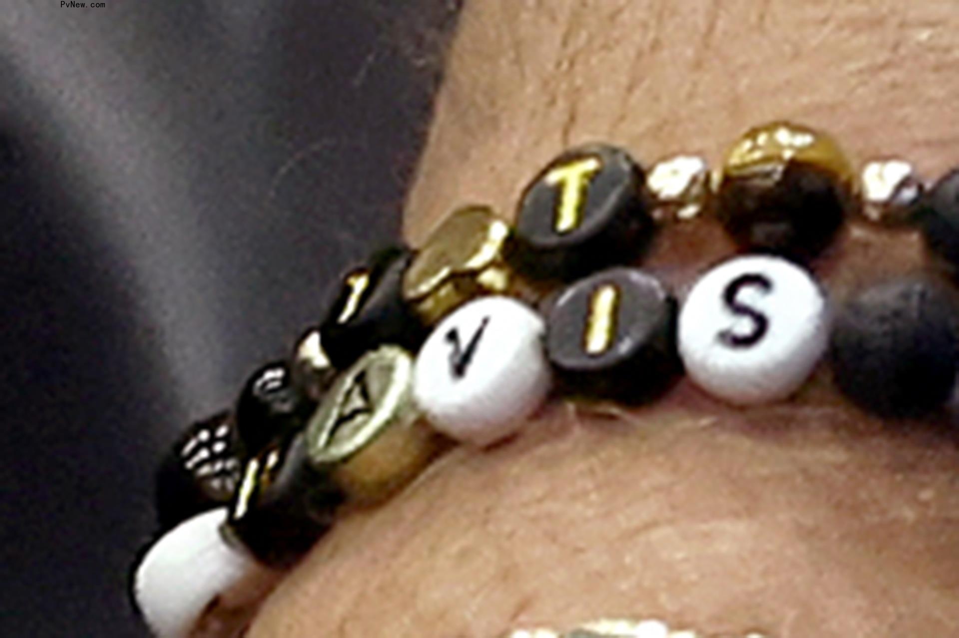 Travis Kelce's bracelets at Jason's retirement speech.