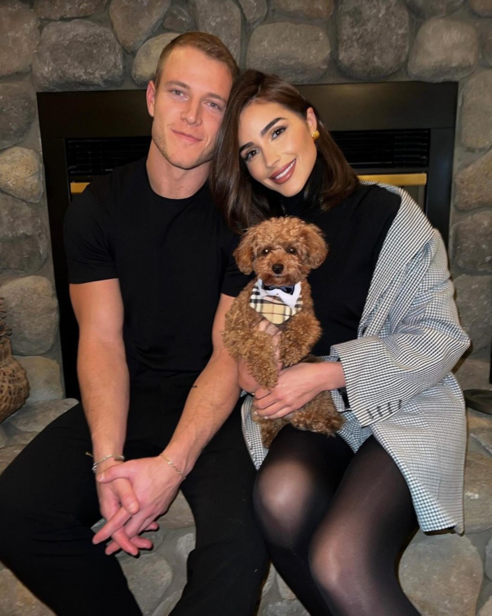 Christian McCaffrey and Olivia Culpo with their dog.