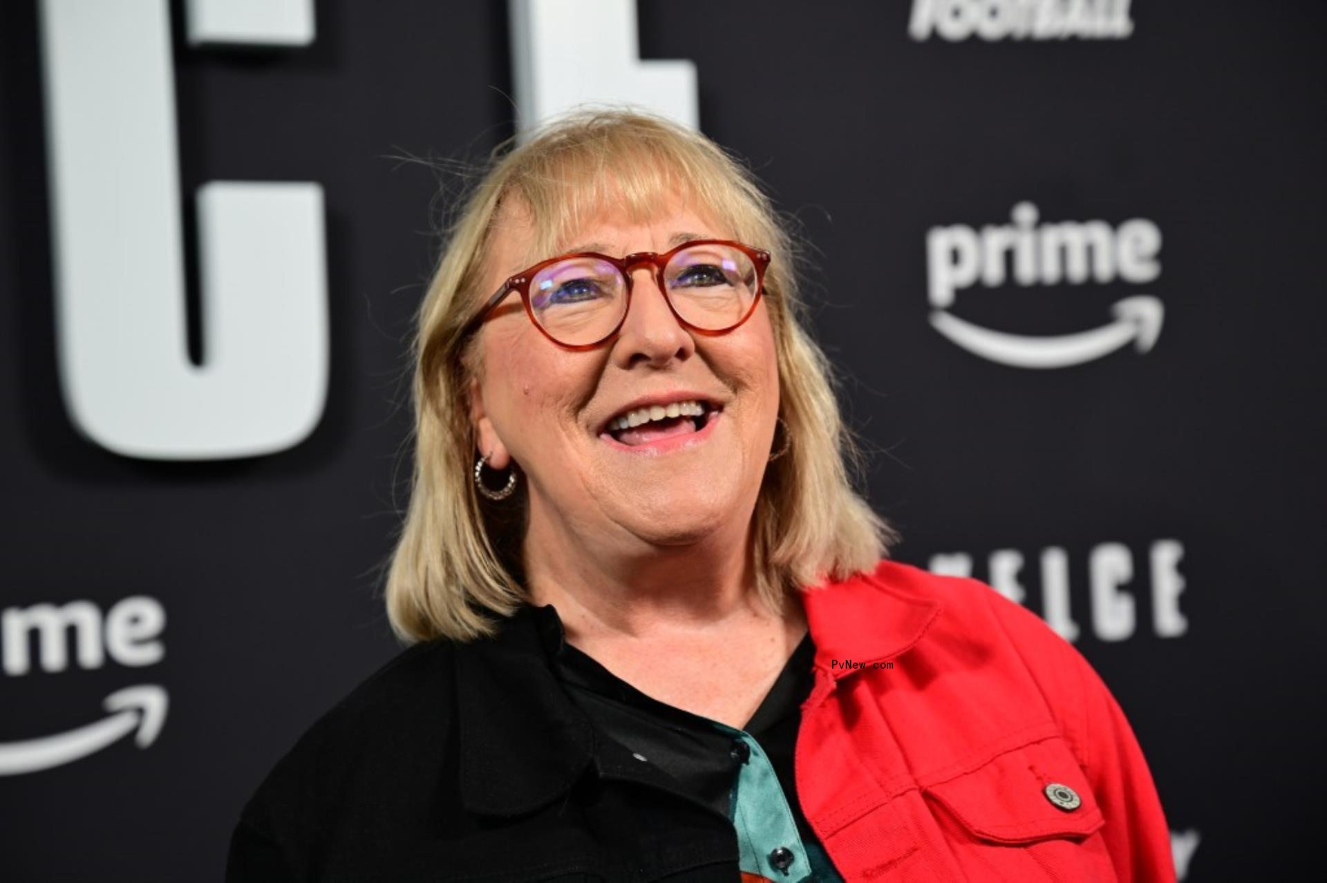 Do<i></i>nna Kelce smiles in a red and black jacket.