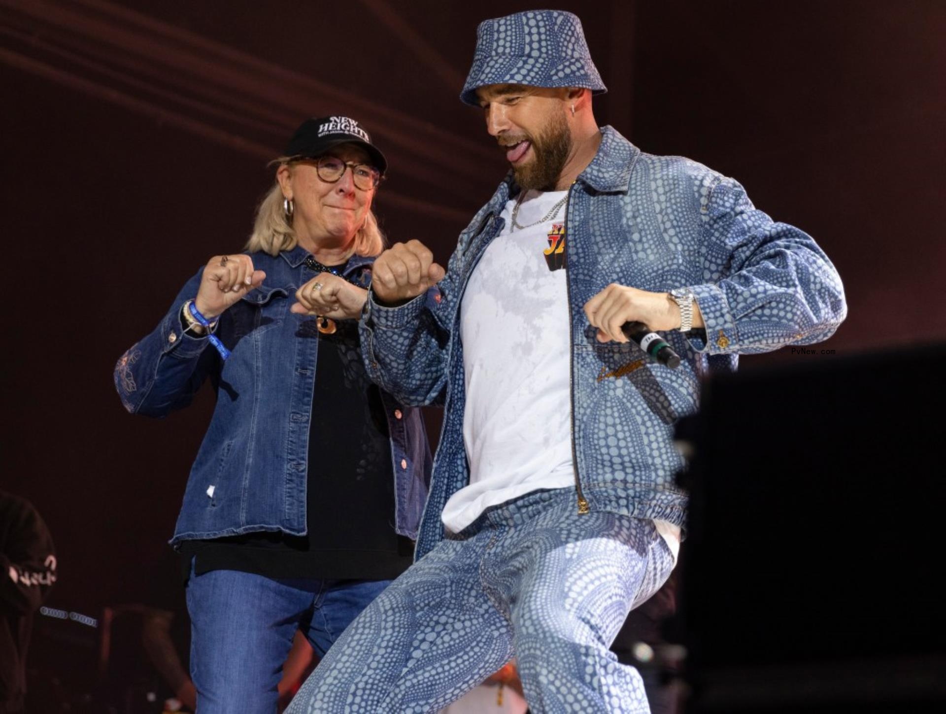 Travis and Do<i></i>nna Kelce in jean outfits dance on a stage