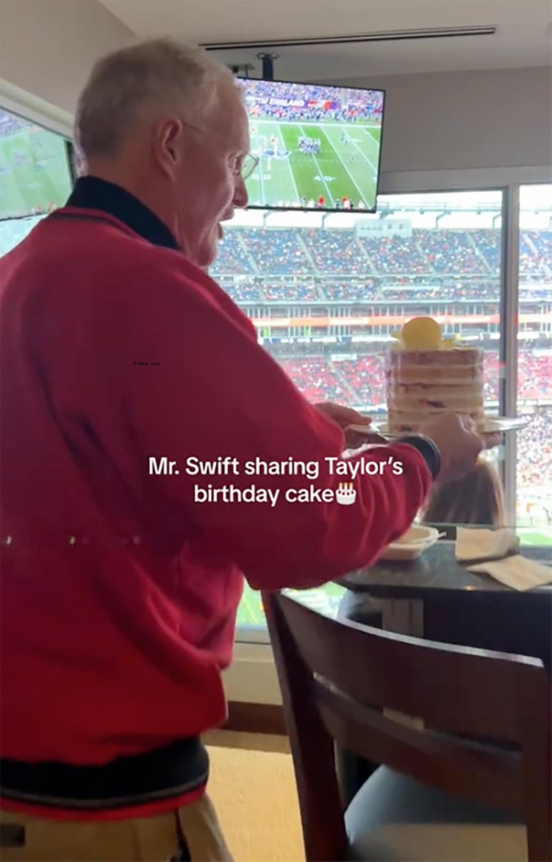 Scott Swift holding cake.