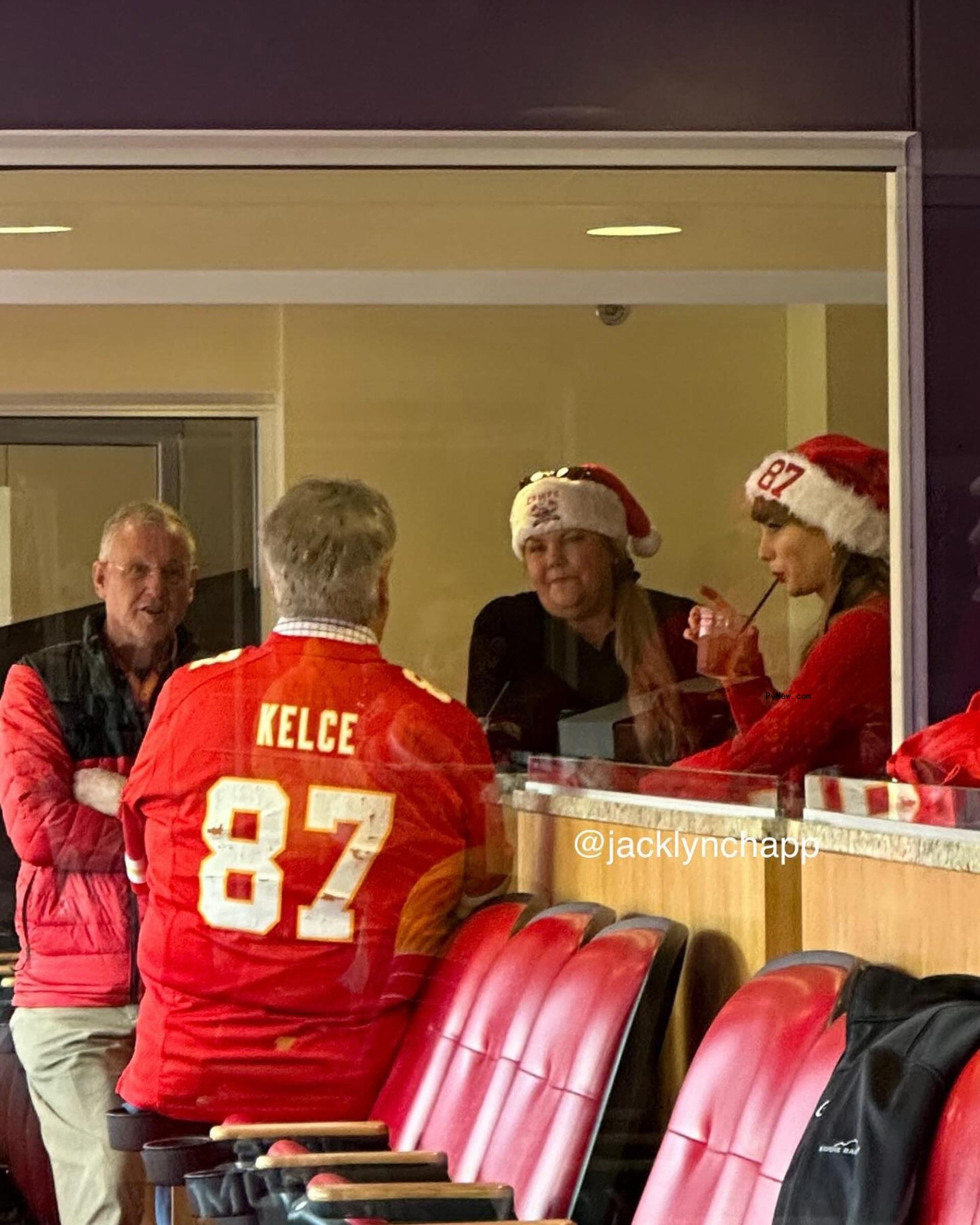 Taylor Swift and her parents parents mingling with Travis Kelce's dad, Ed Kelce, in a suite.