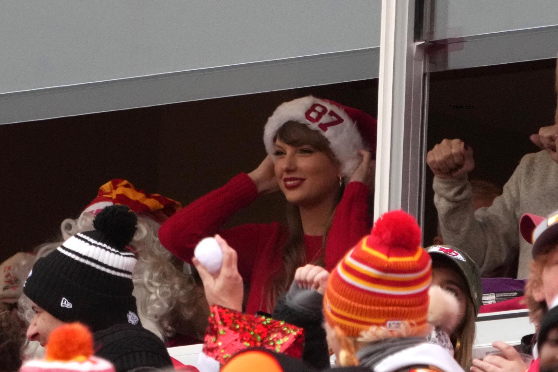 Taylor Swift wearing a Santa hat at a Kansas City Chiefs game.