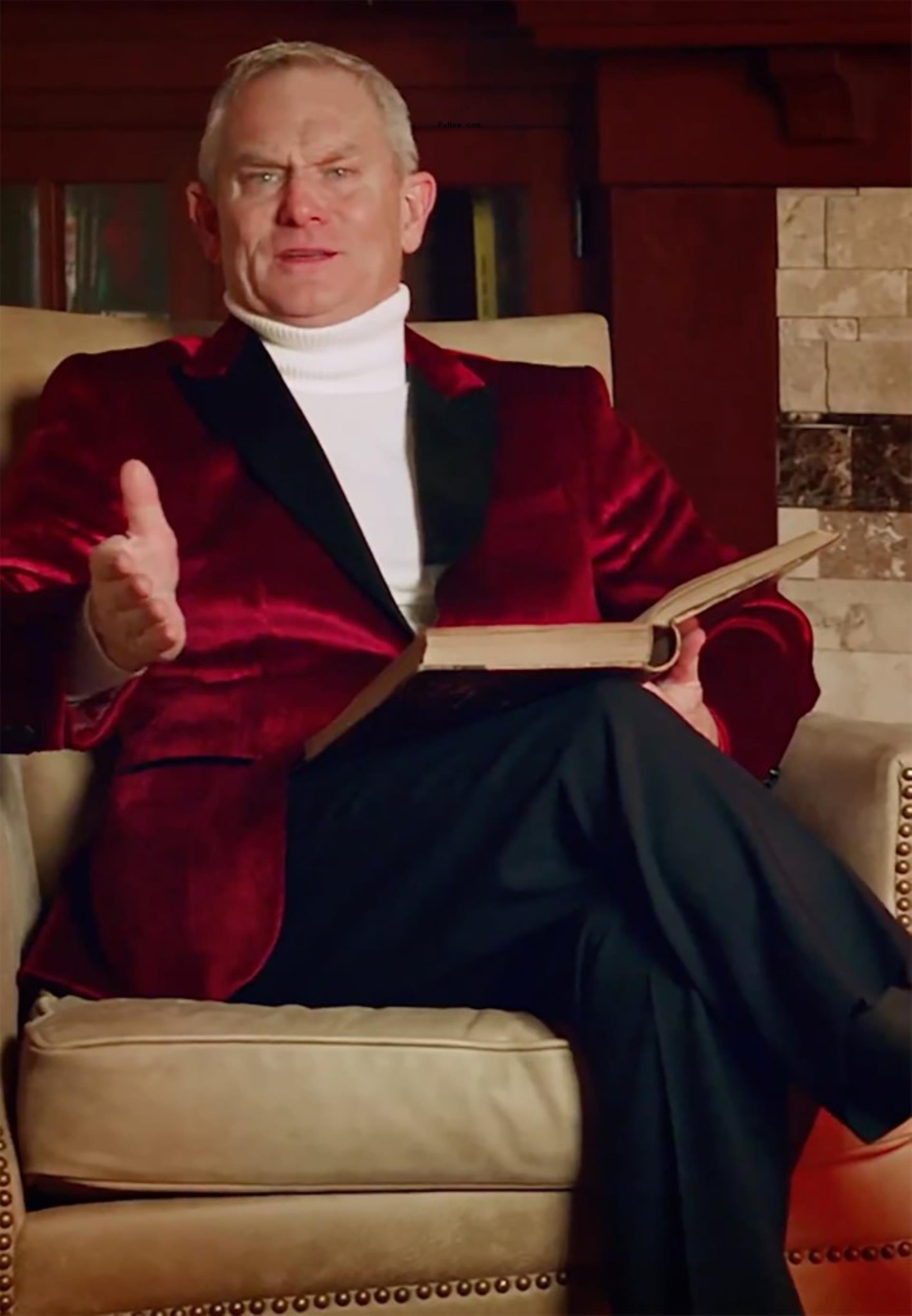 a man sitting in a chair reading a story book