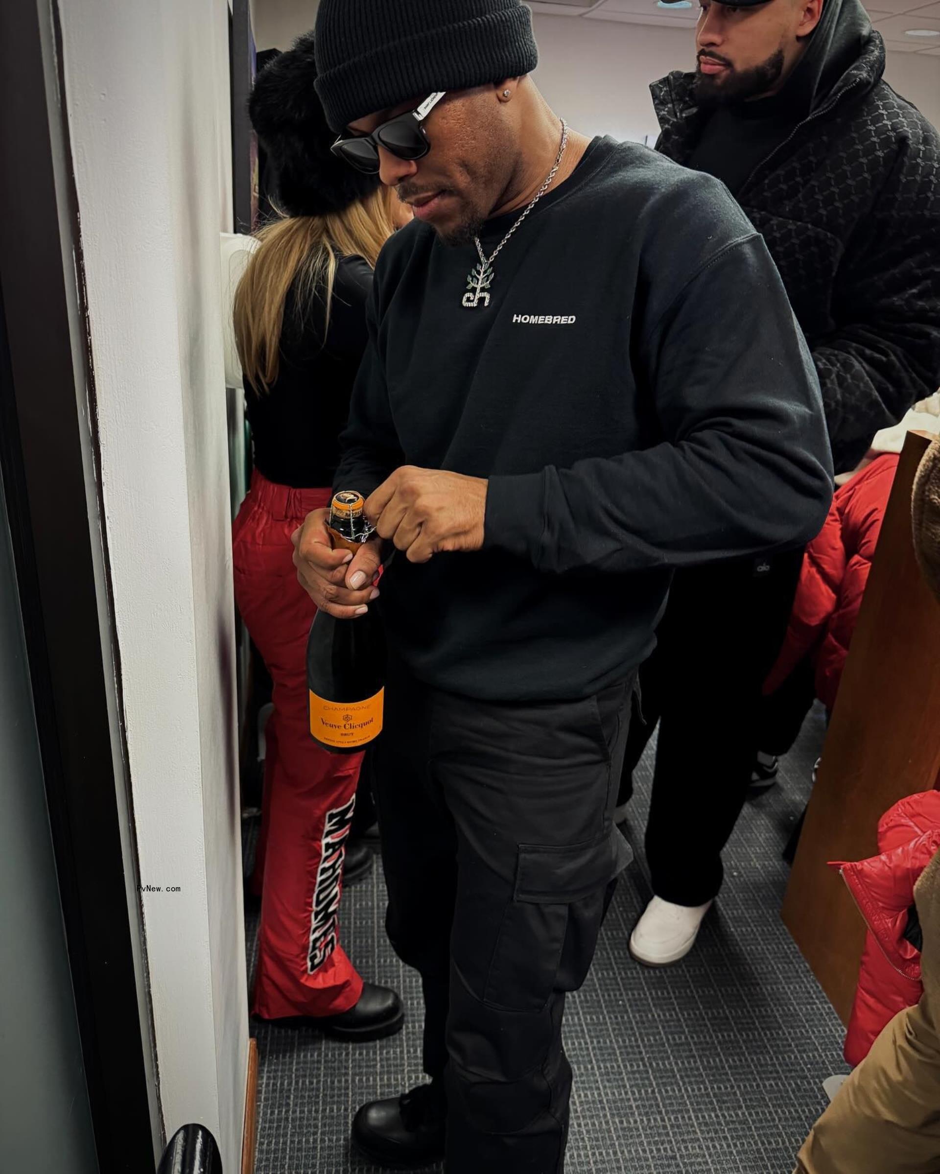 Aric Jo<i></i>nes drinking champagne