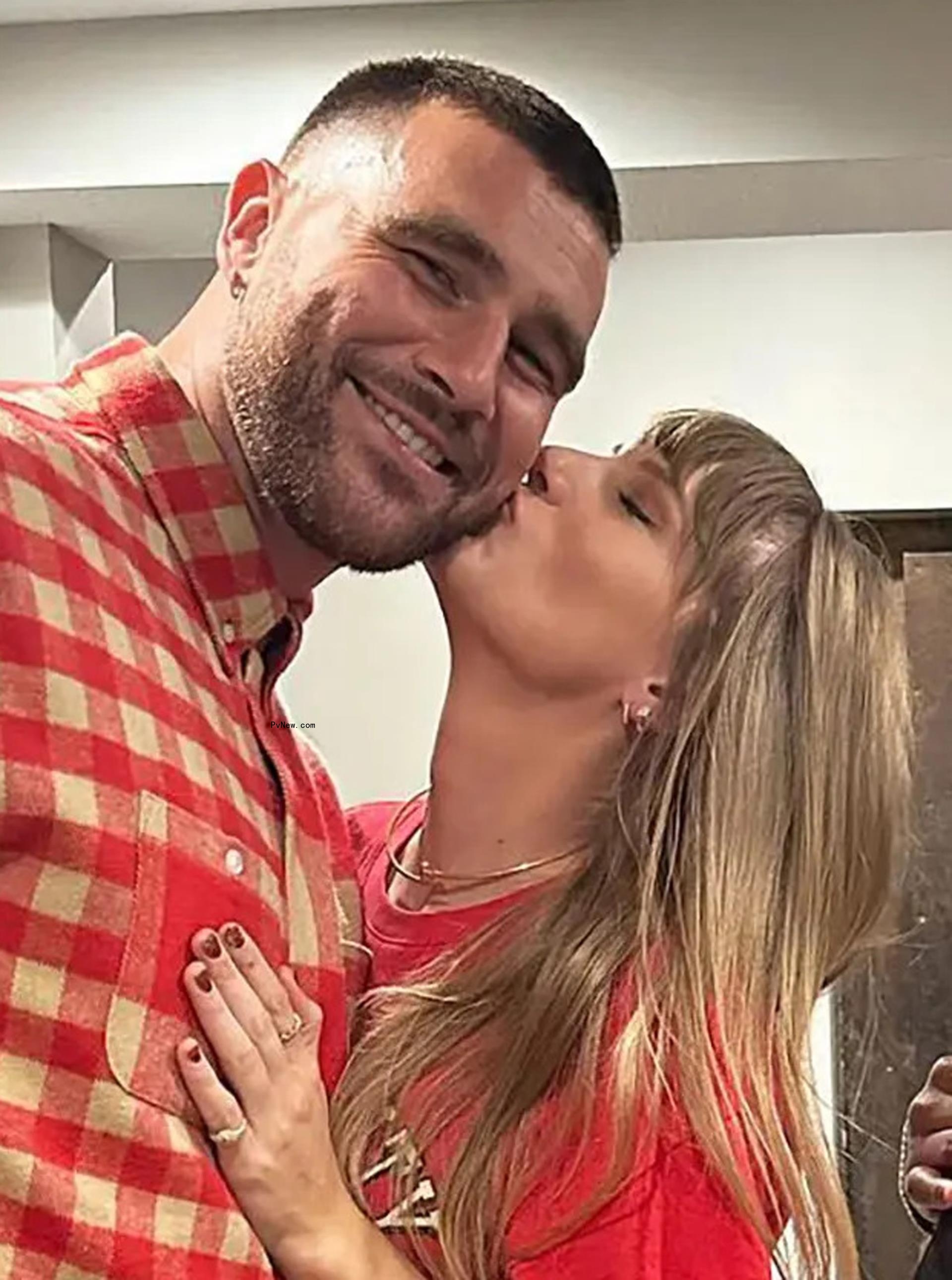 Taylor Swift kissing Travis Kelce on the cheek.
