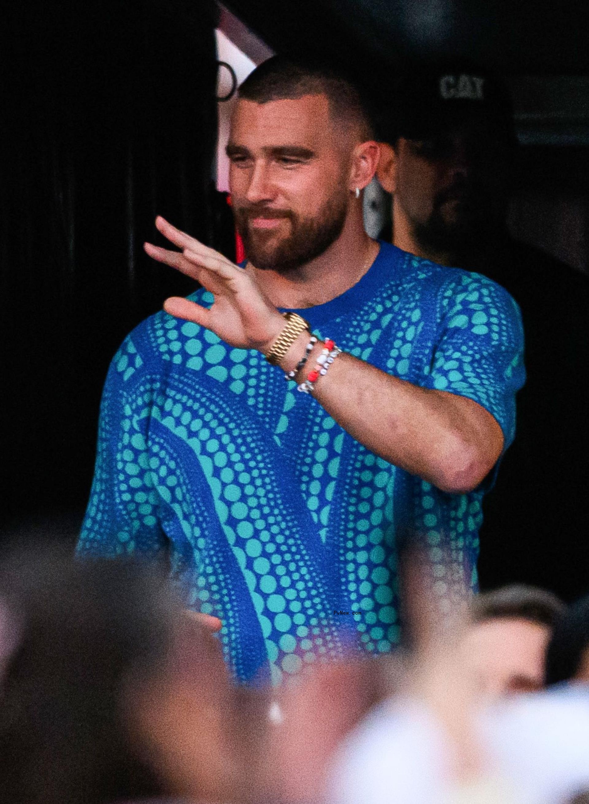 Travis Kelce waving at fans.