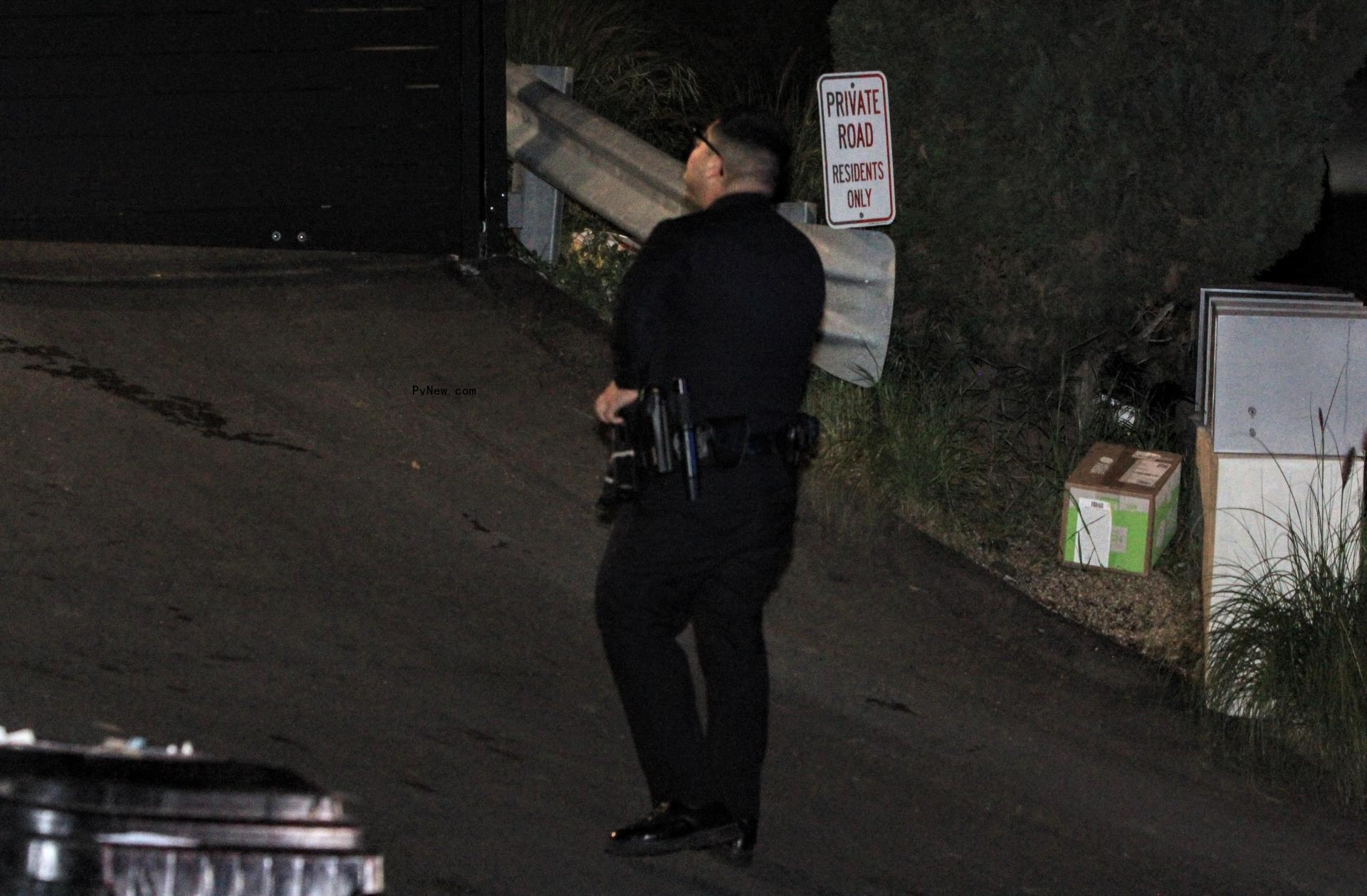 a police officer walking up a private road