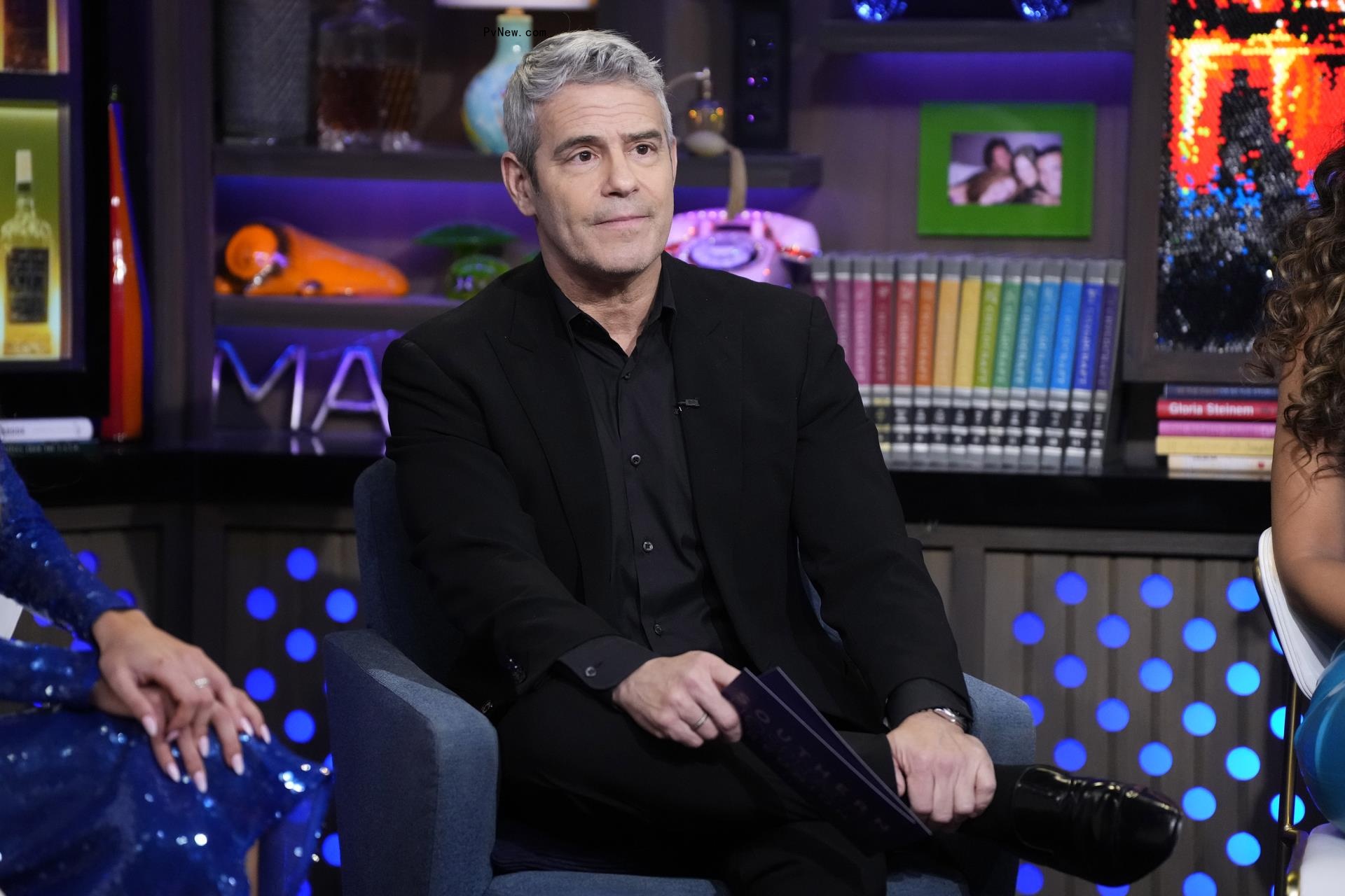 Andy Cohen sitting on 