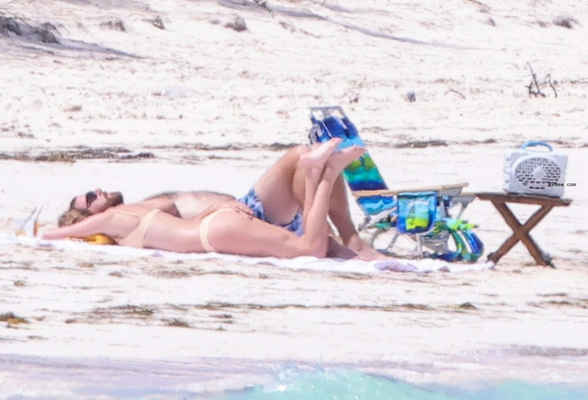 Taylor Swift and Travis Kelce seen kissing in bathing suits on PDA-packed Bahamas vacation