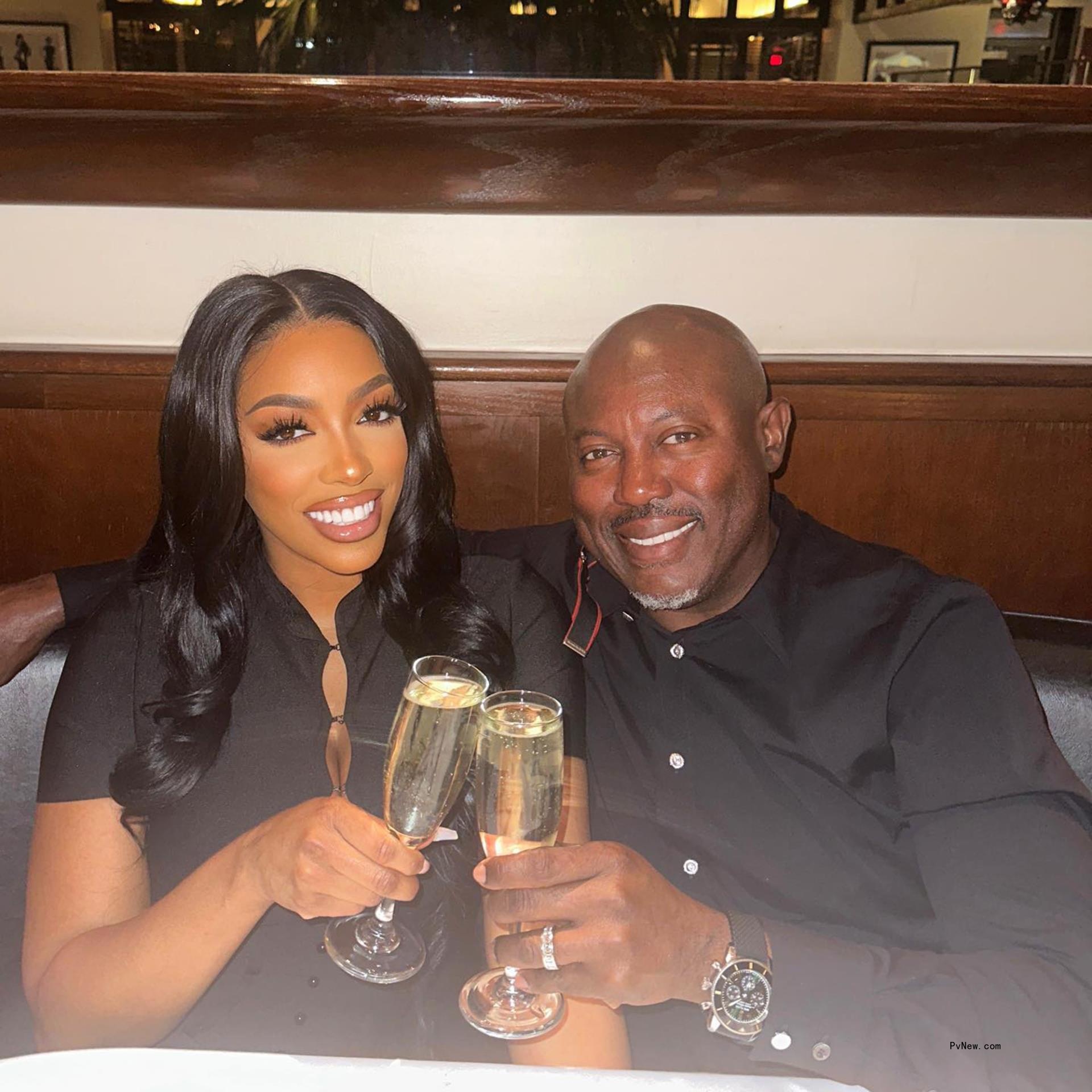 Porsha Williams and Simon Guobadia cl<i></i>inking champagne glasses