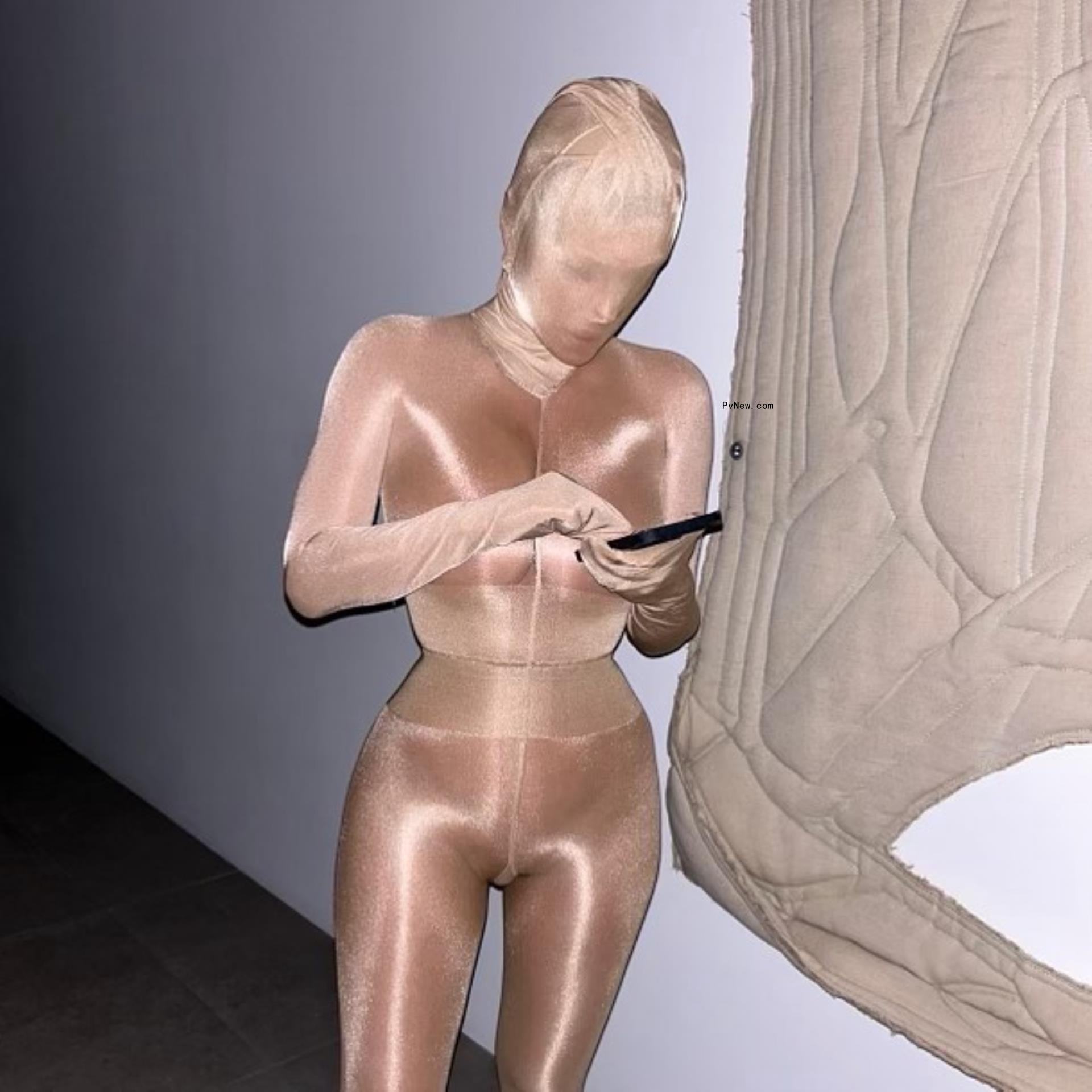 Bianca Censori covered head to toe in copper colored fabric