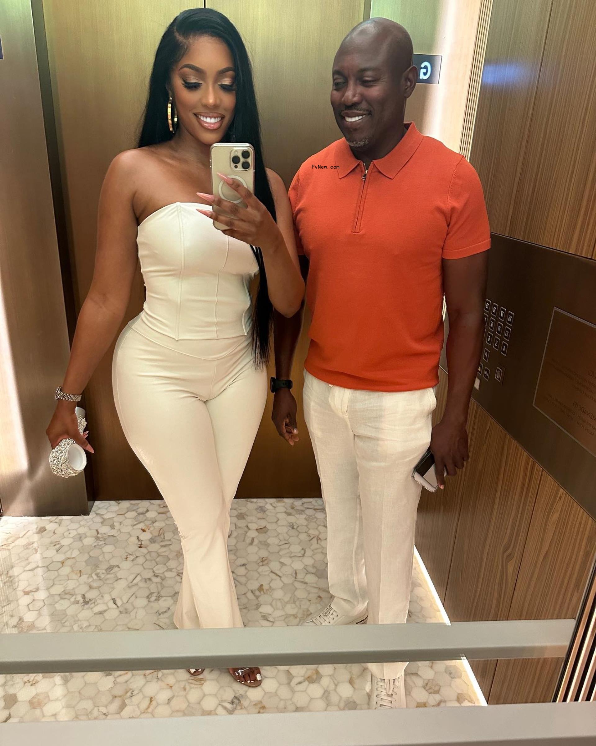 porsha williams and simon guobadia taking a mirror selfie in elevator