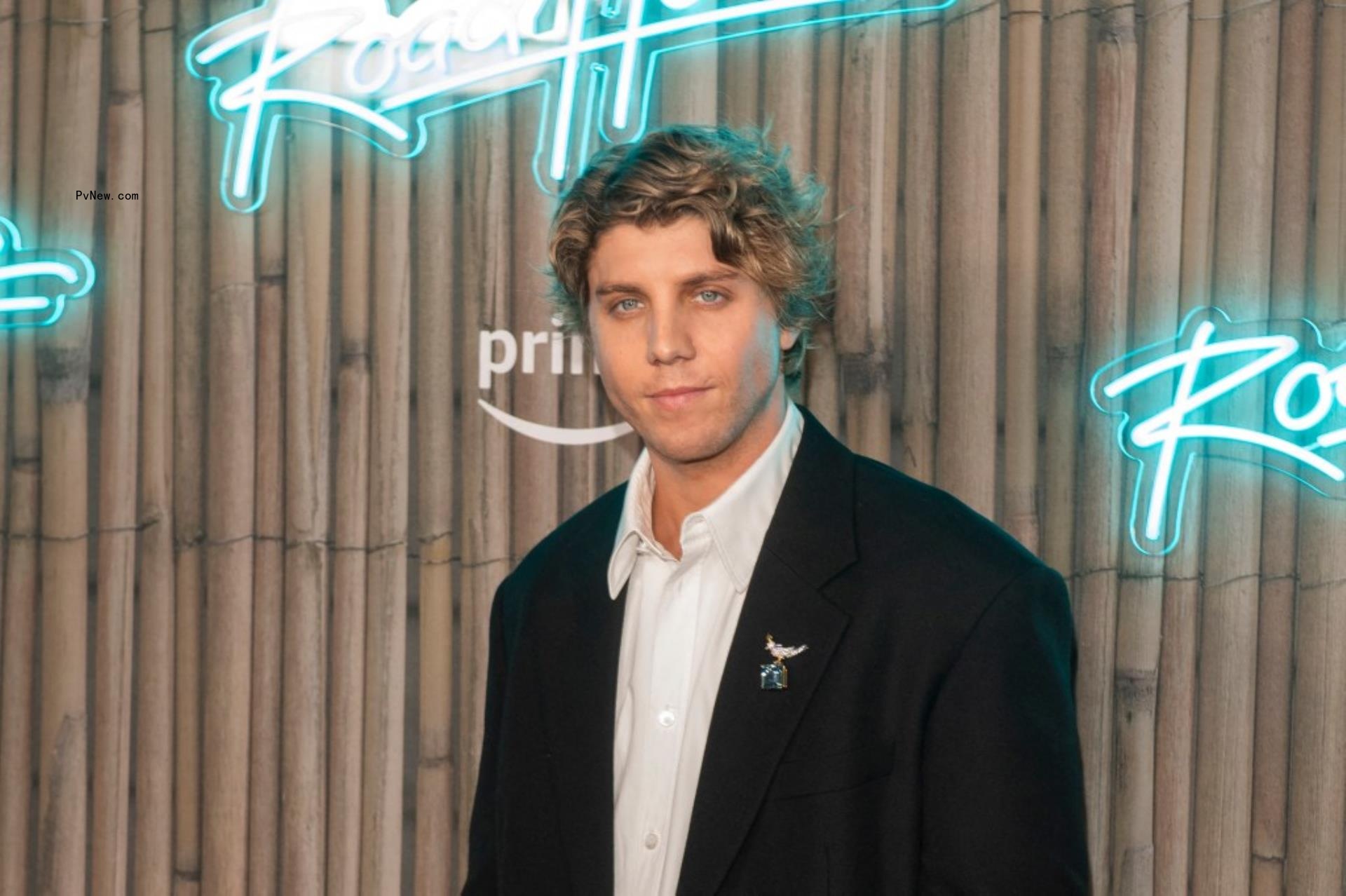 Lukas Gage posing on red carpet.