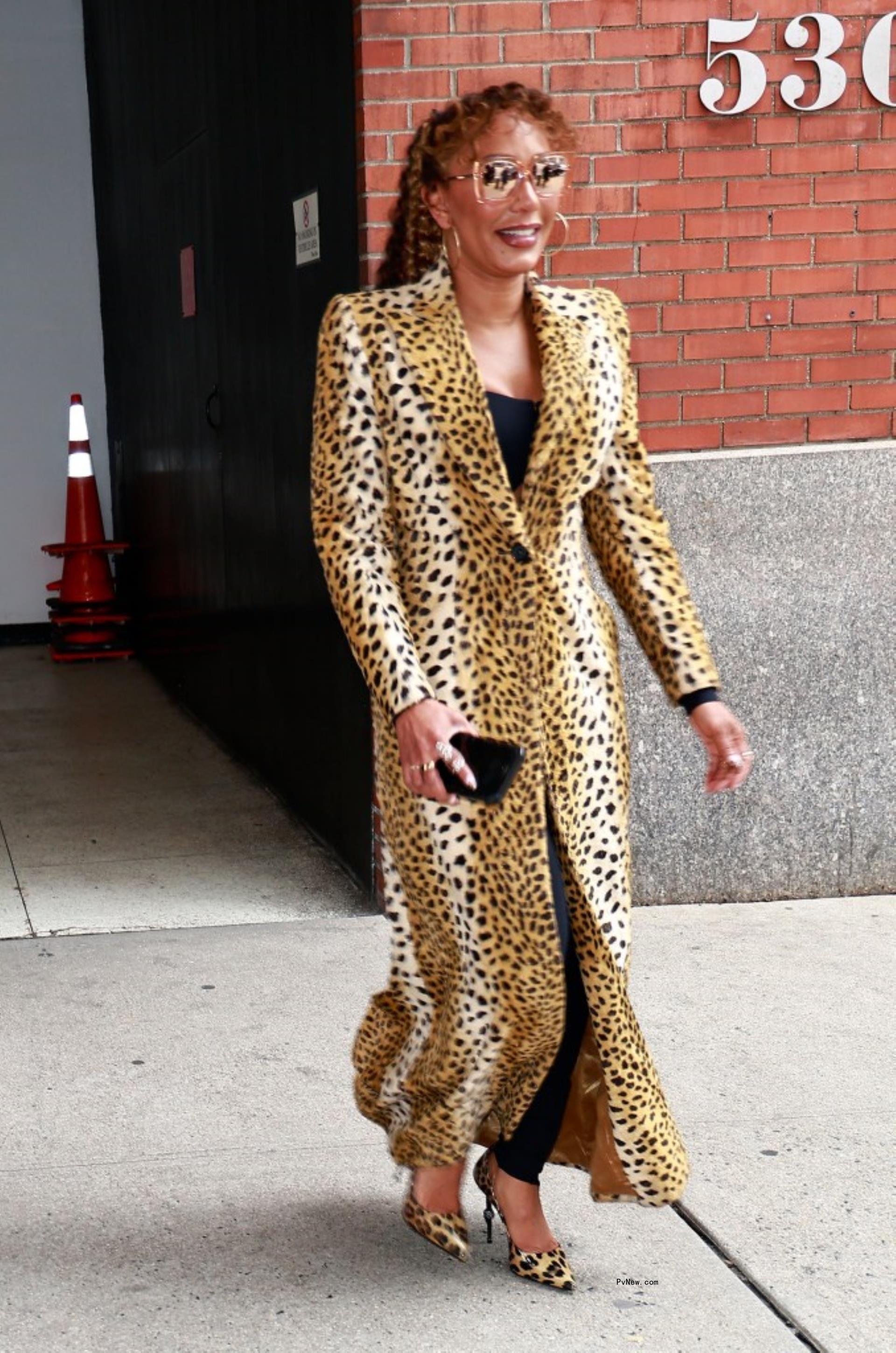 Mel B exits Drew Barrymore show wearing a leopard print trench coat in New York City.