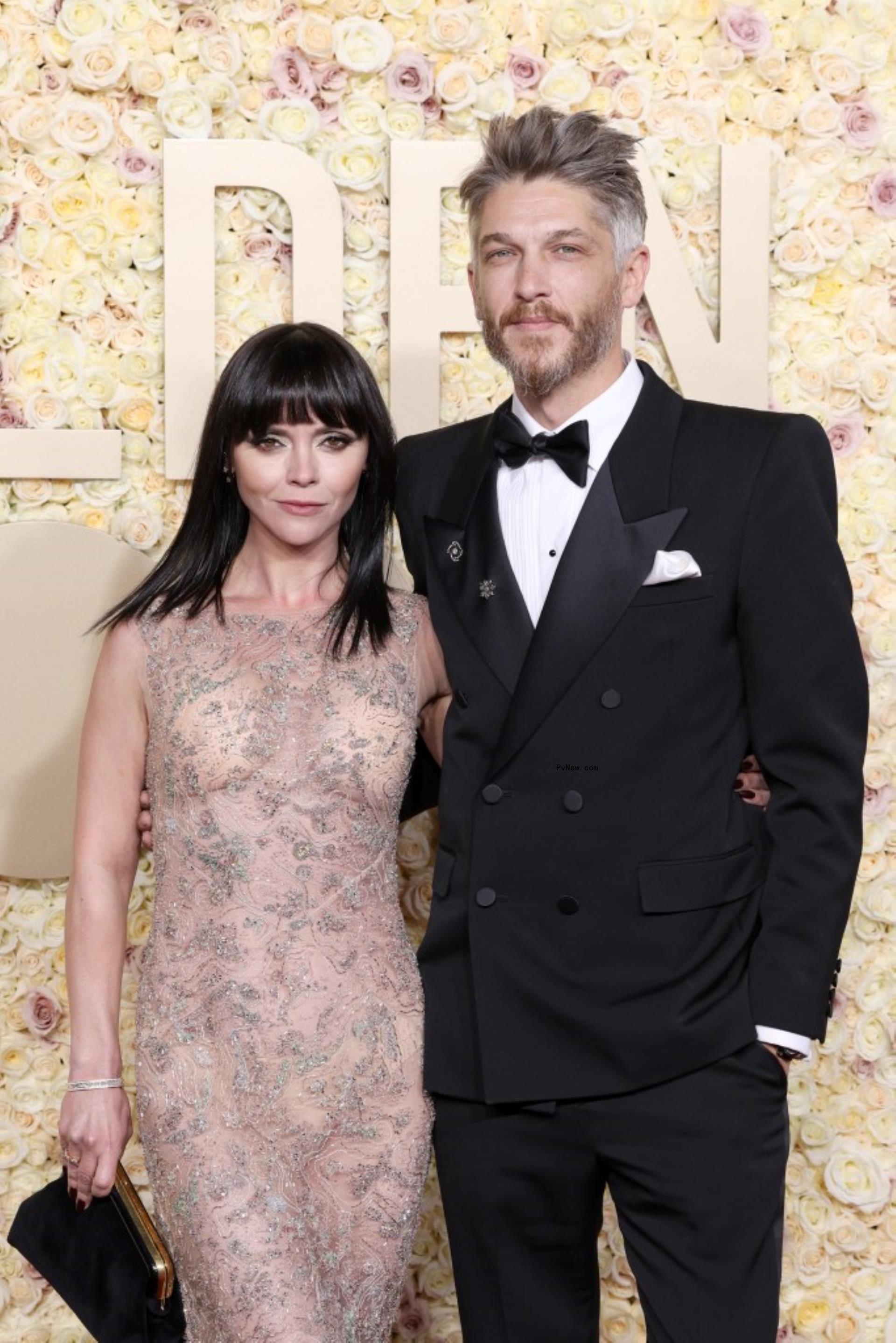 Christina Ricci and Mark Hampton pose for red carpet photos. 