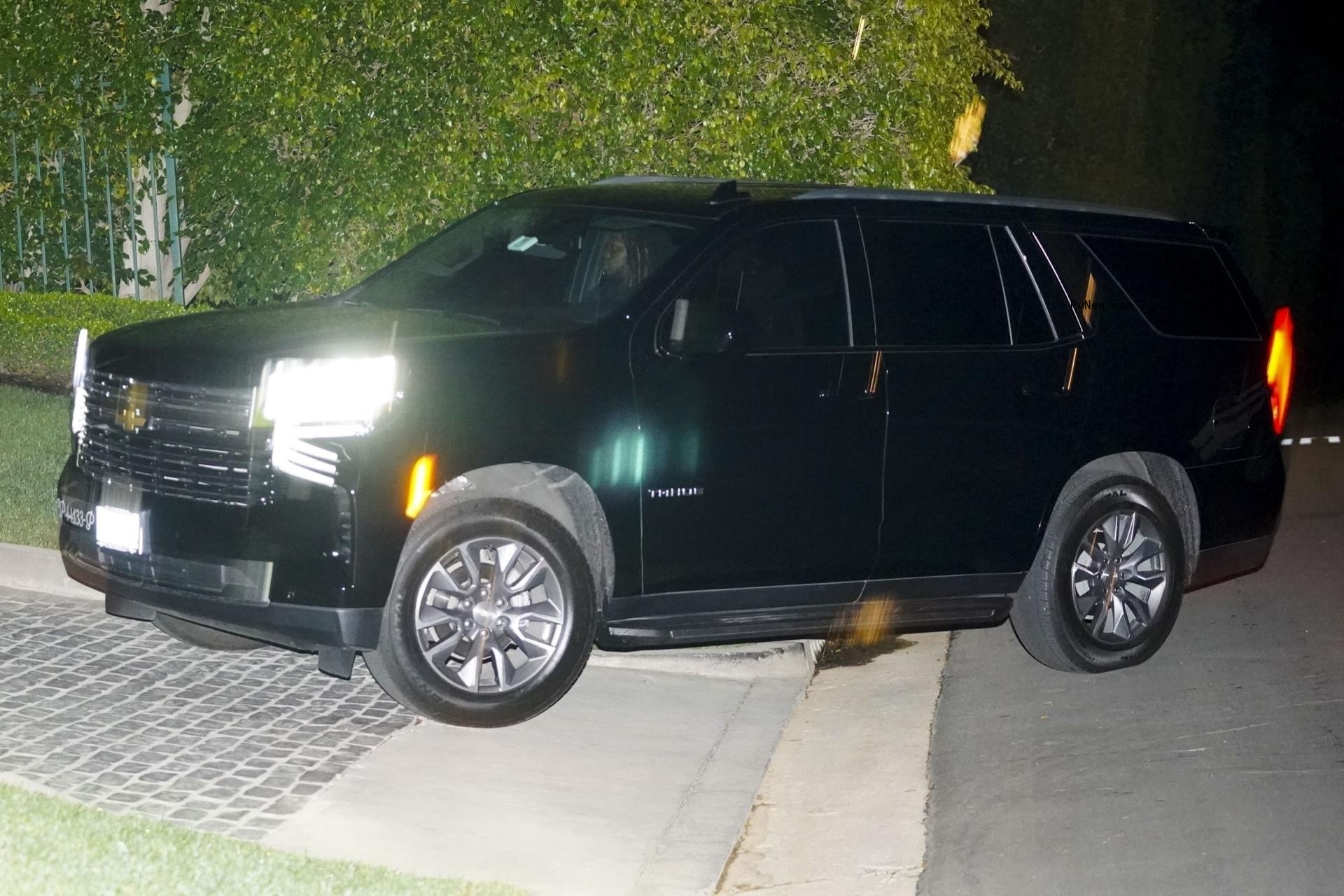 two men and a woman in an suv
