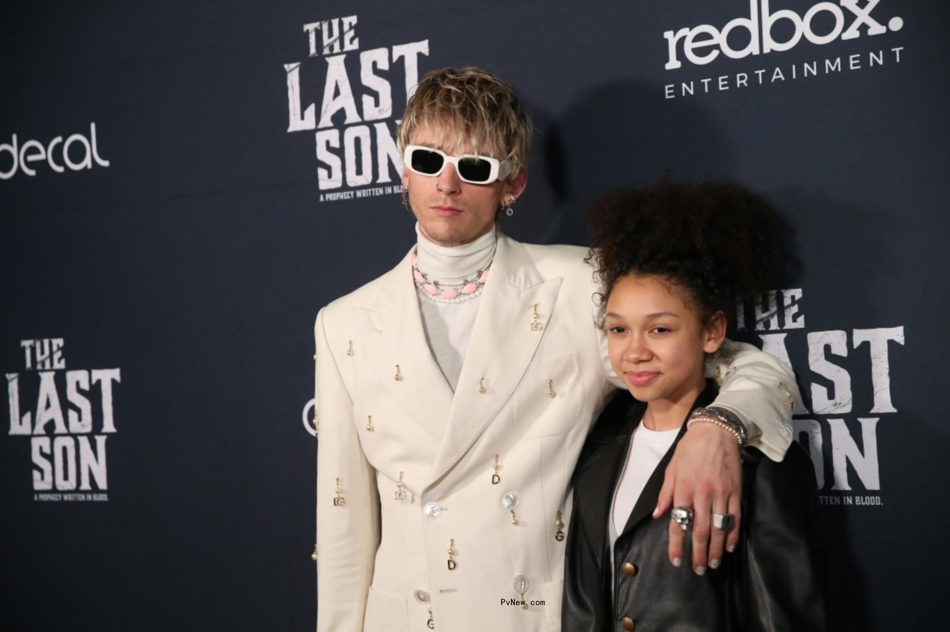 Machine Gun Kelly and daughter Casie on a red carpet.