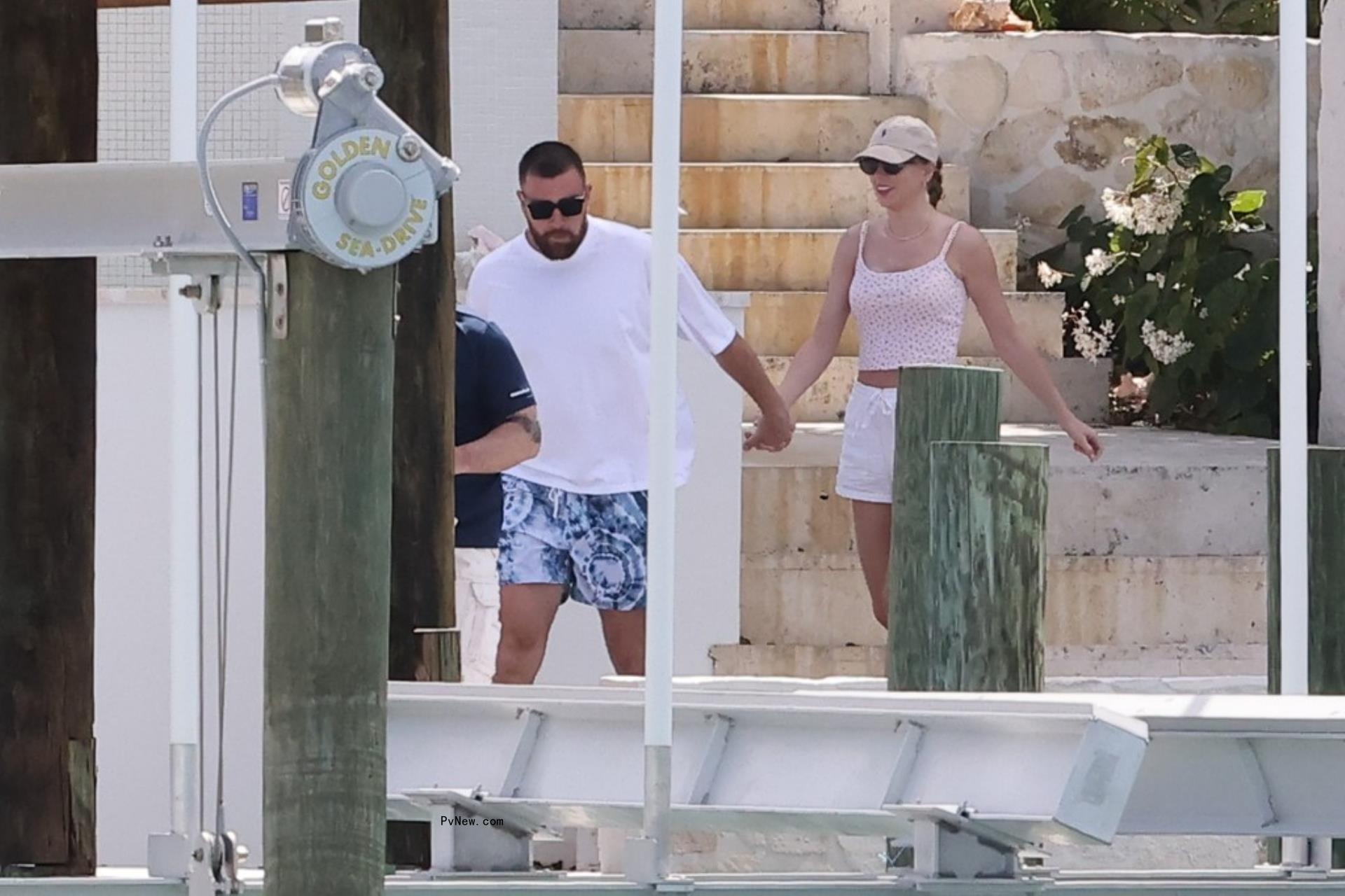 Travis Kelce and Taylor Swift holding hands in the Bahamas.