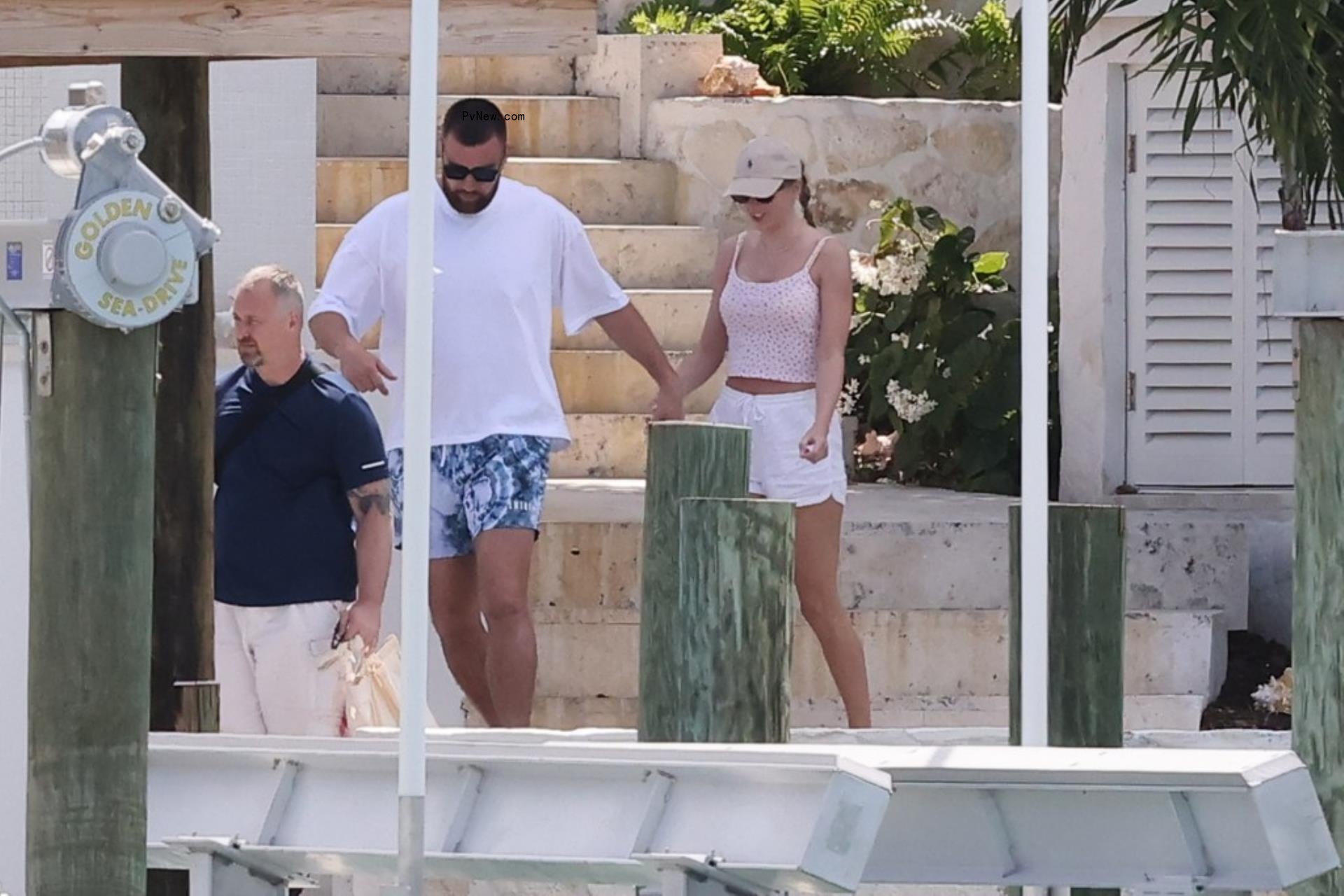 Travis Kelce and Taylor Swift holding hands in the Bahamas.