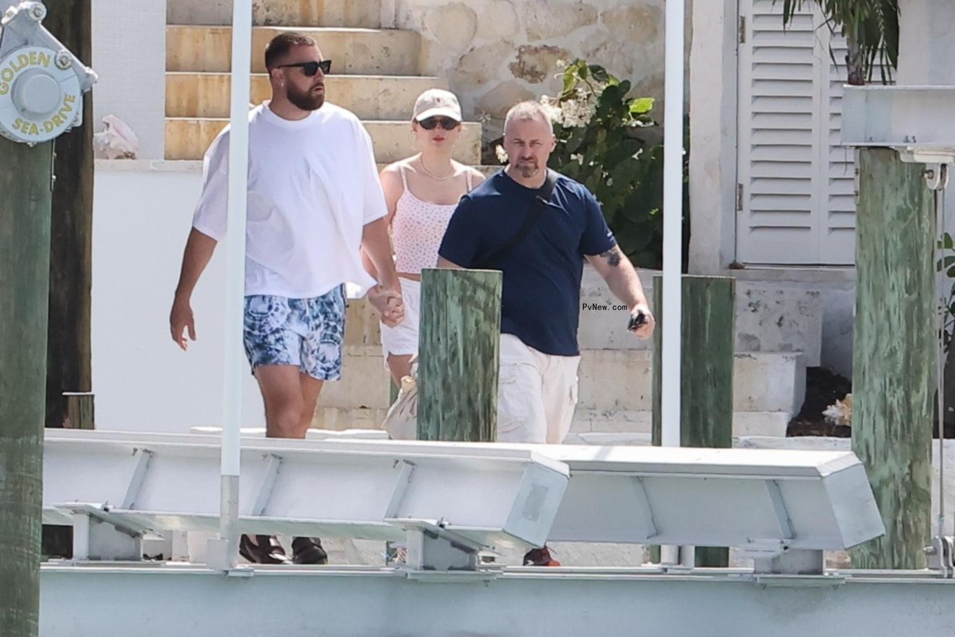 Travis Kelce and Taylor Swift holding hands in the Bahamas.